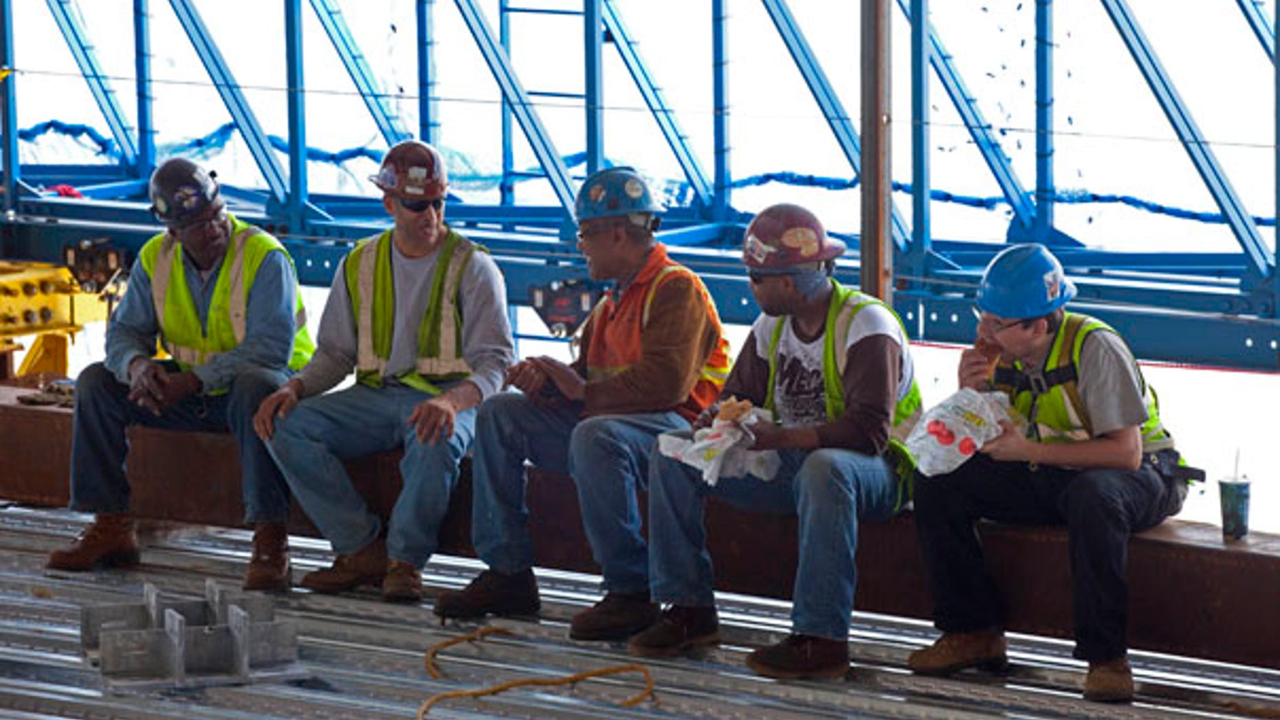 June 18: Construction workers take a lunch break inside the rising structure of One World Trade Center in New York. A Subway sandwich shop is serving workers atop the Ground Zero scaffolding that will become Freedom Tower. The eatery, built out of shipping containers, is rising along with the signature skyscraper with the help of a hydraulically powered platform.