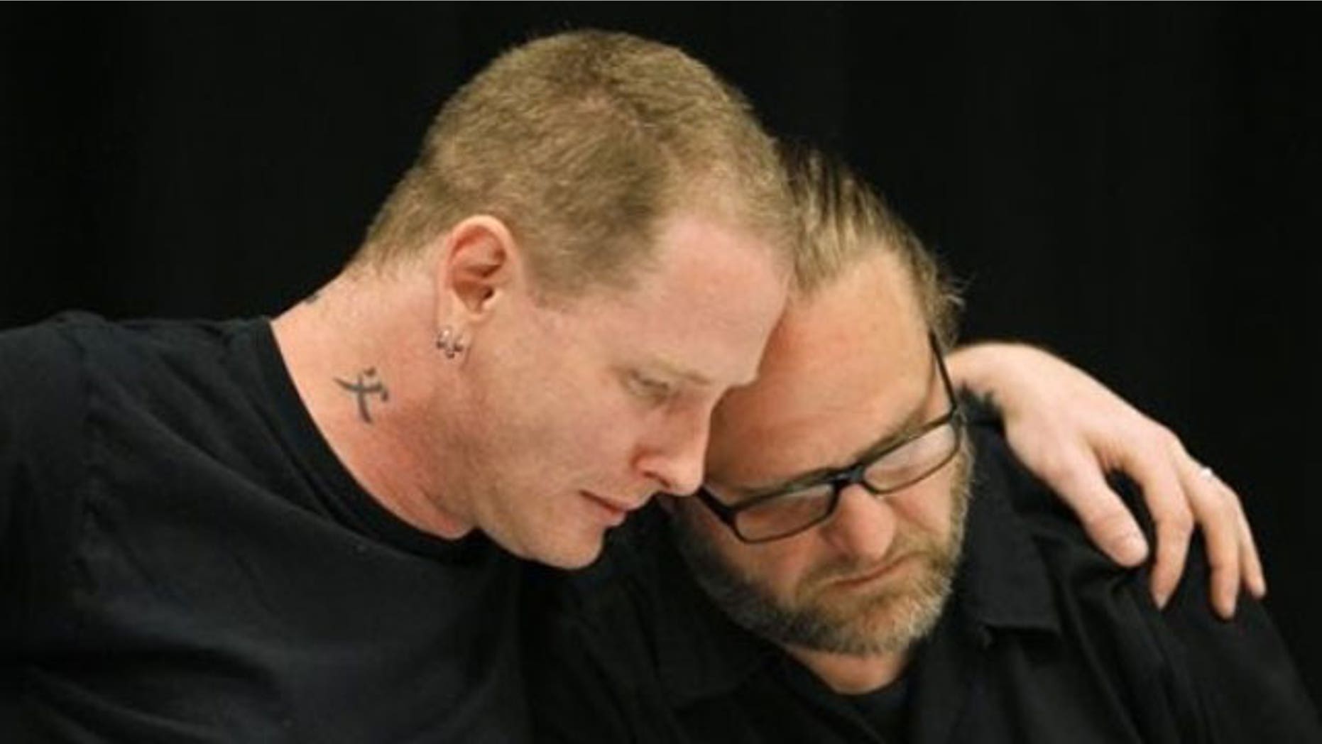 May 25: Slipknot lead singer Corey Taylor, left, reacts with band member Shawn Crahan after speaking about the death of bassist Paul Gray during a news conference in Des Moines, Iowa.