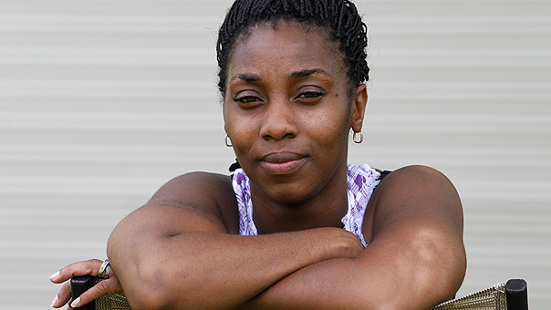 June 21: Nicole Robbins, 31, a single mother, poses in the backyard of her home in Indianapolis. Robbins, has used Planned Parenthood services for about six years, a Medicaid recipient, she is impacted by the state’s funding cutoff under the new state law.