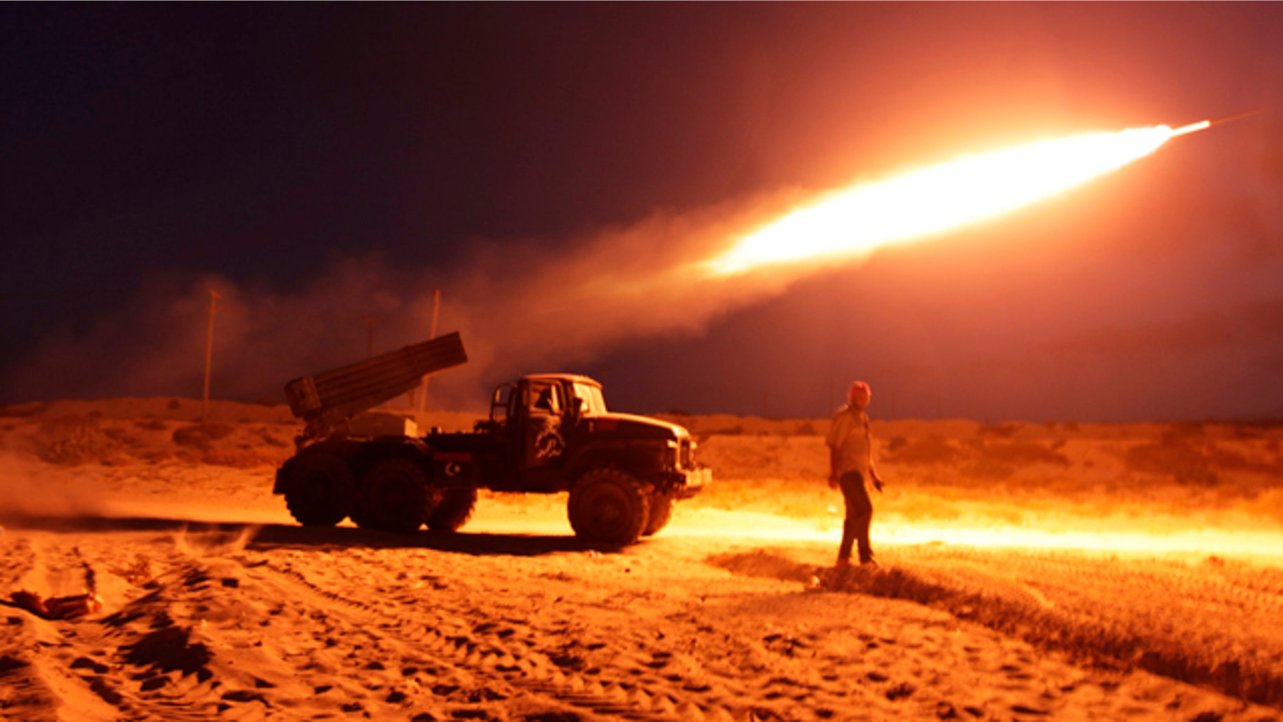 June 20: Rebel fighters fire a Grad rocket at the front line west of Misrata, Libya.