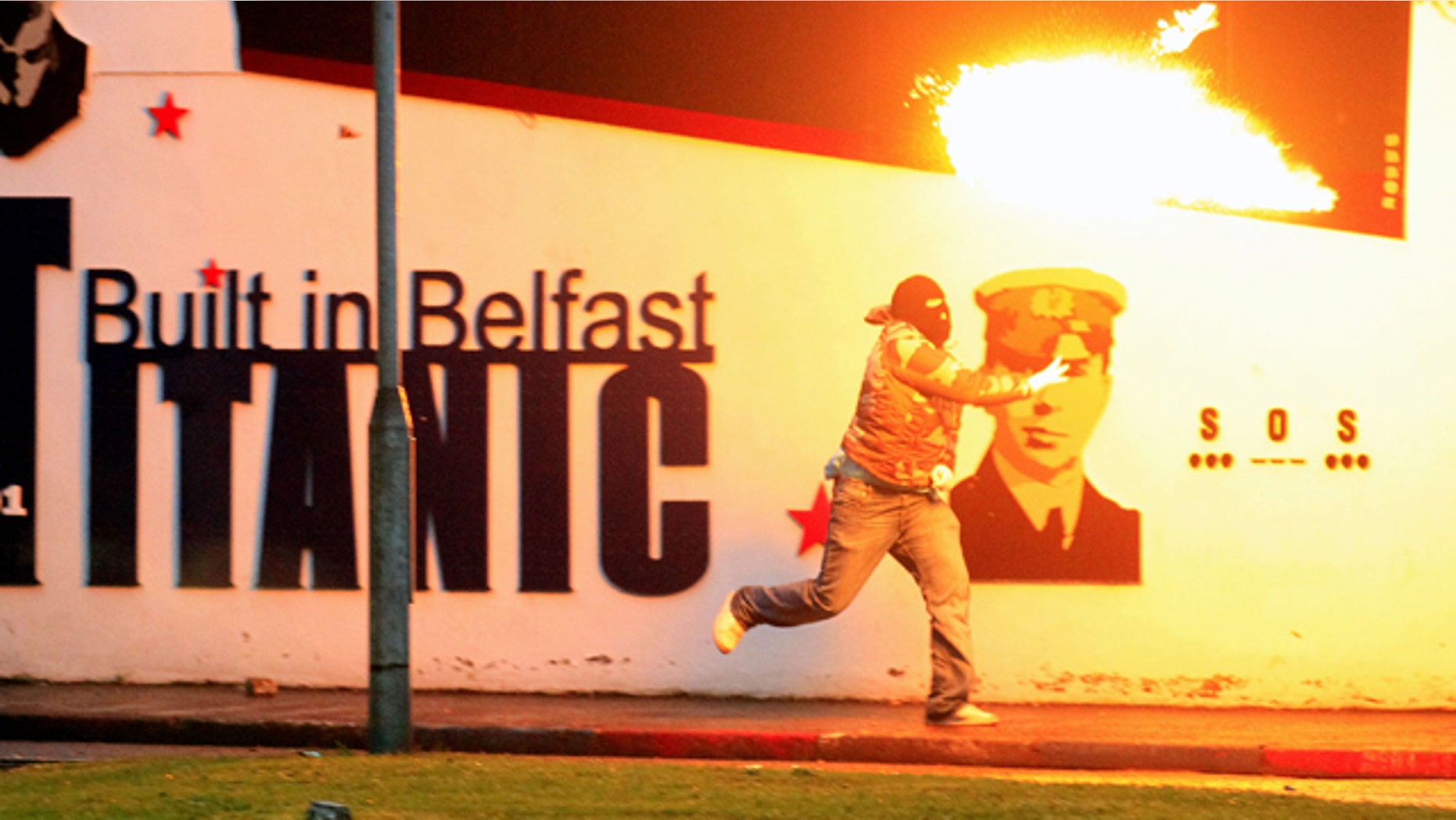 June 21: Loyalist rioters throw petrol bombs towards the mainly Catholic Short Strand area of East Belfast, Northern Ireland.