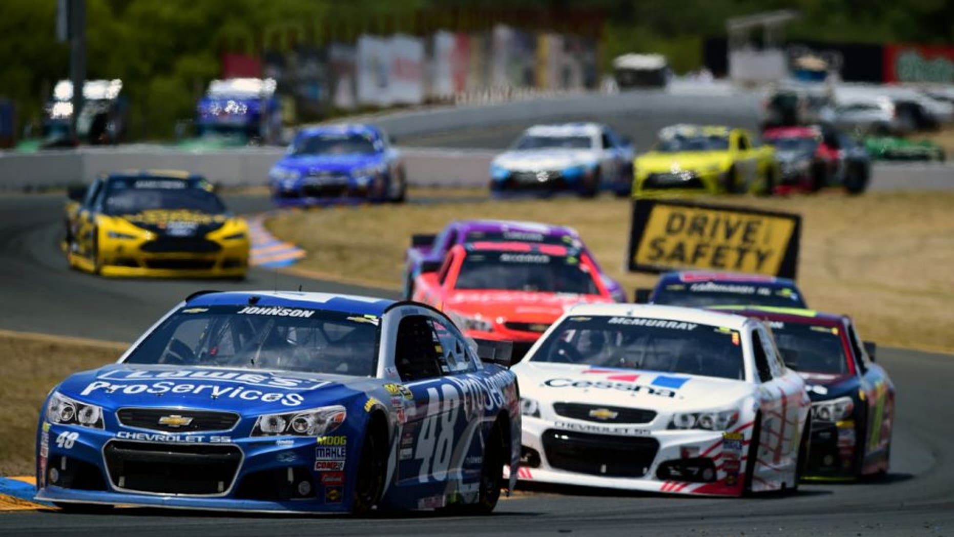 SONOMA, CA - JUNE 28: Jimmie Johnson, driver of the #48 Lowe's Pro Services Chevrolet, leads a pack of cars during the NASCAR Sprint Cup Series Toyota/Save Mart 350 at Sonoma Raceway on June 28, 2015 in Sonoma, California. (Photo by Jared C. Tilton/Getty Images)