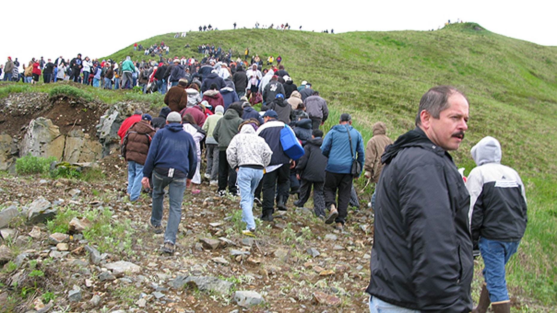 June 23: Fish processing workers and local residents head up the hill after a tsunami warning was issued in Unalaska's Dutch Harbor, in Alaska's Aleutian Islands.