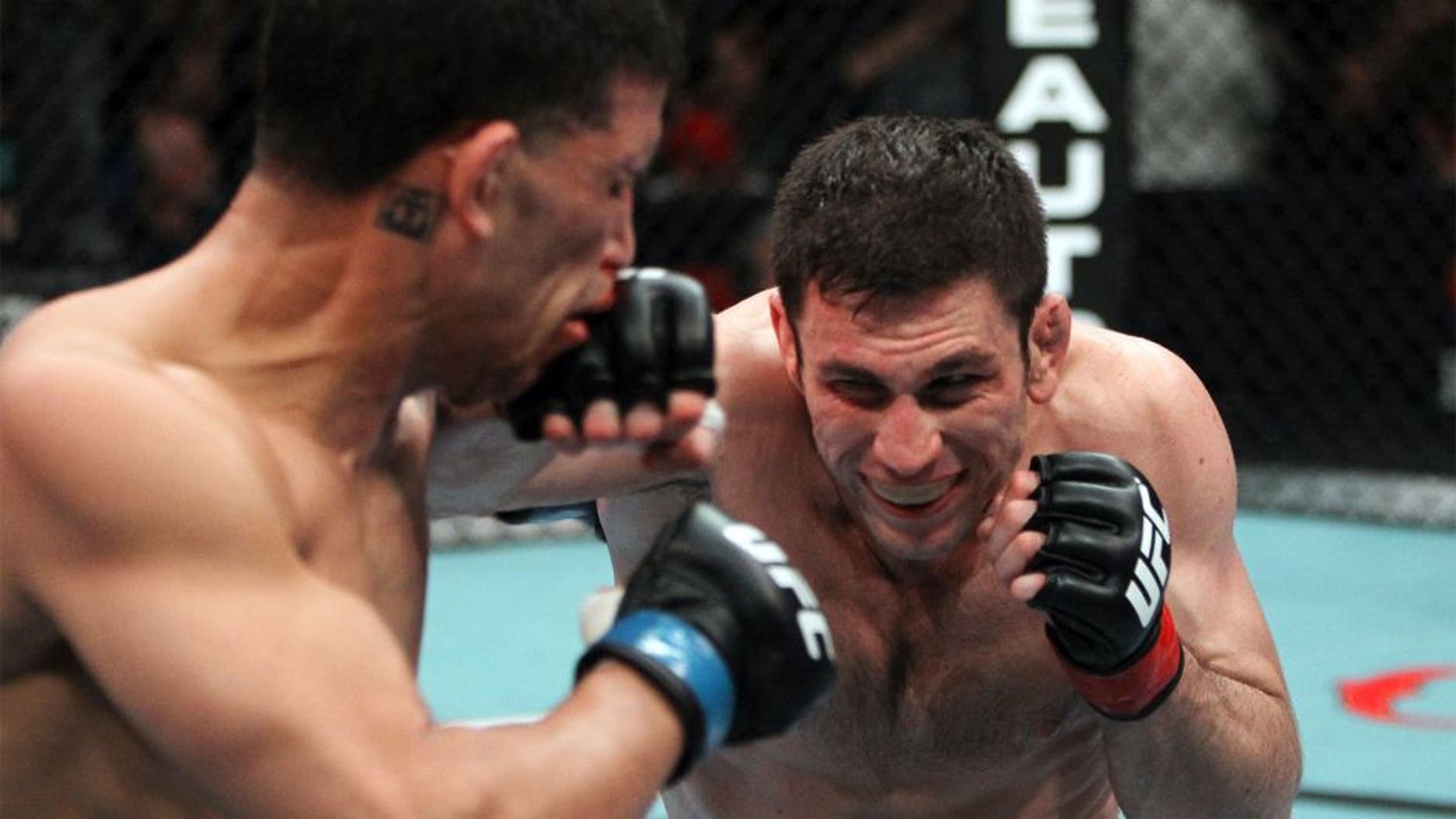 SEATTLE - MARCH 26: (R-L) Amir Sadollah punches DaMarques Johnson during their welterweight bout at the UFC Fight Night 24 event at Key Arena on March 26, 2011 in Seattle, Washington. (Photo by Josh Hedges/Zuffa LLC/Zuffa LLC via Getty Images) *** Local Caption *** Amir Sadollah;DaMarques Johnson