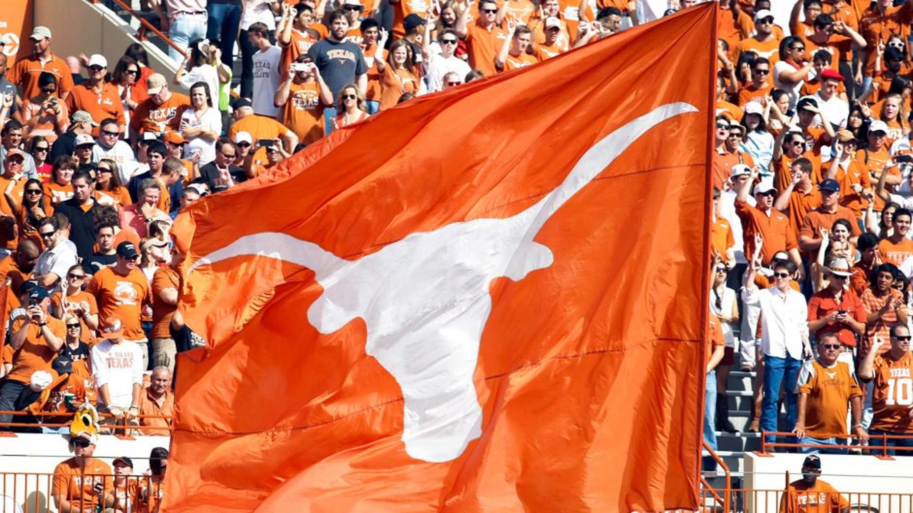 Nov 10, 2012; Austin, TX, USA; Texas Longhorns cheerleaders wave a flag after a touchdown against the Iowa State Cyclones in the first quarter at Darrell K Royal-Texas Memorial Stadium. Mandatory Credit: Brett Davis-USA TODAY Sports