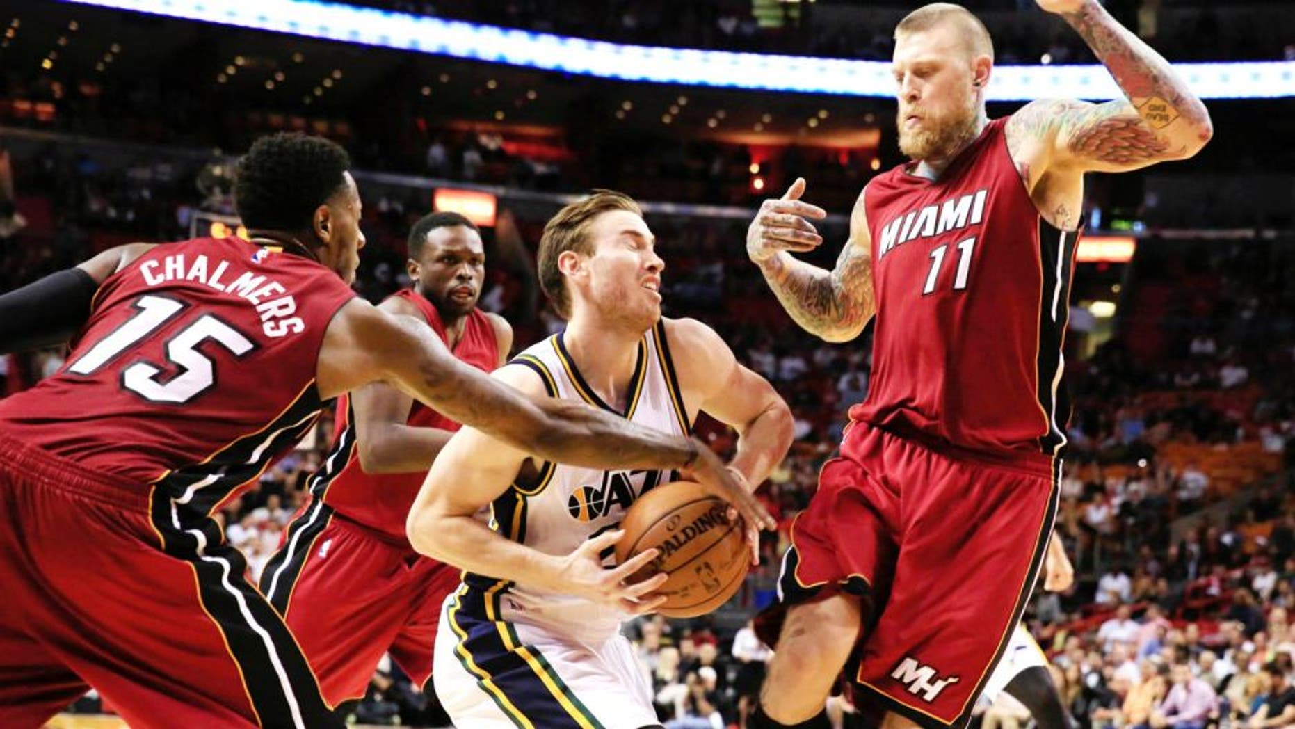 Dec 17, 2014; Miami, FL, USA; Utah Jazz forward Gordon Hayward (20) is defended by Miami Heat guard Mario Chalmers (15) and forward Chris Andersen (11) in the second half at American Airlines Arena. The Jazz won 105-87. Mandatory Credit: Robert Mayer-USA TODAY Sports