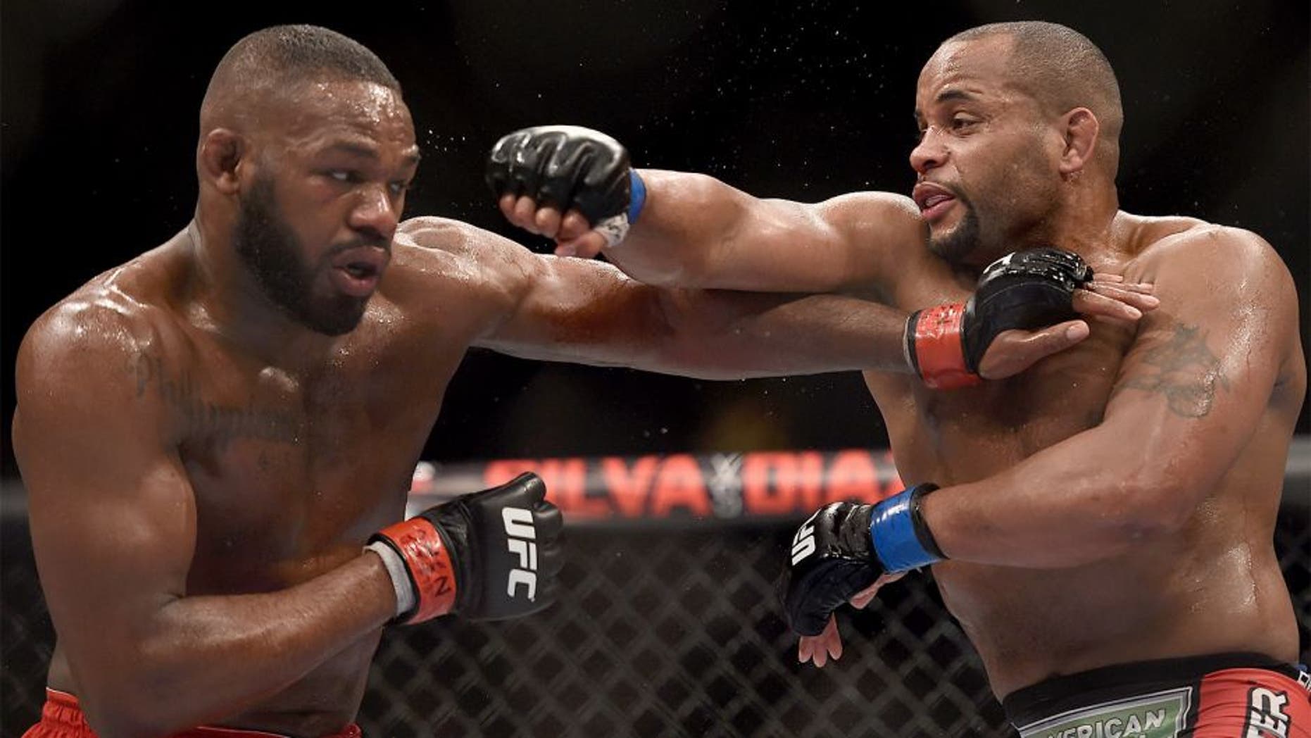 LAS VEGAS, NV - JANUARY 03: Jon Jones (L) and Daniel Cormier (R) exchange punches in their UFC light heavyweight championship bout during the UFC 182 event at the MGM Grand Garden Arena on January 3, 2015 in Las Vegas, Nevada. (Photo by Jeff Bottari/Zuffa LLC/Zuffa LLC via Getty Images)