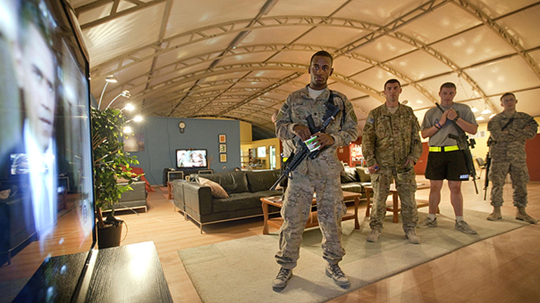 June 23: Spc. Gavin Fruge, 22, of Crowley, La., left, watches a rebroadcast of President Obama's speech on proposed troop withdrawal with fellow soldiers at Kandahar Airfield in Kandahar, Afghanistan.
