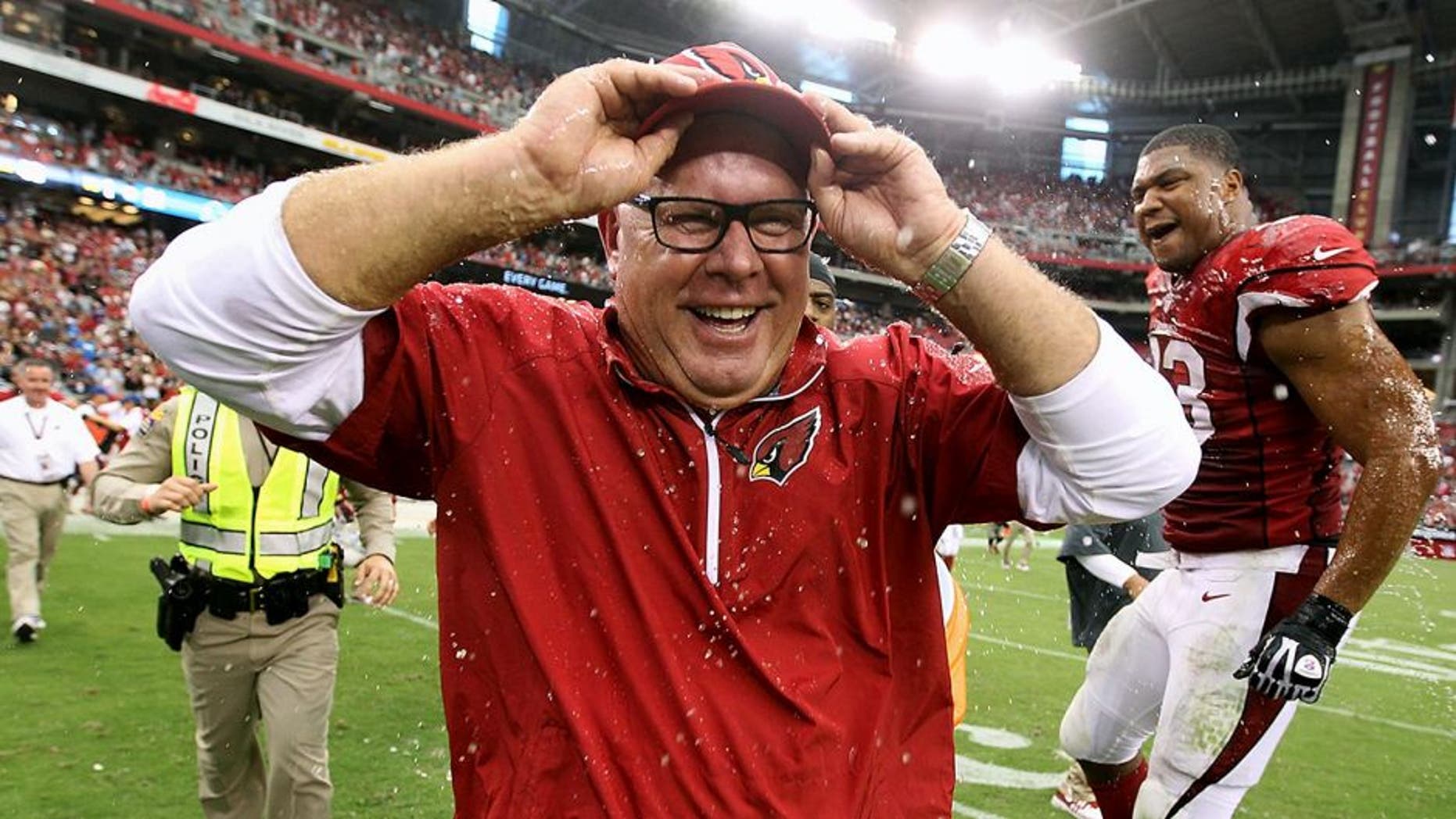 GLENDALE, AZ - SEPTEMBER 15: Head coach Bruce Arians of the Arizona Cardinals reacts after being dunked by gatorade from defensive end Calais Campbell #93 following the NFL game against the Detroit Lions at the University of Phoenix Stadium on September 15, 2013 in Glendale, Arizona. The Carindals defeated the Lions 25-21. (Photo by Christian Petersen/Getty Images)