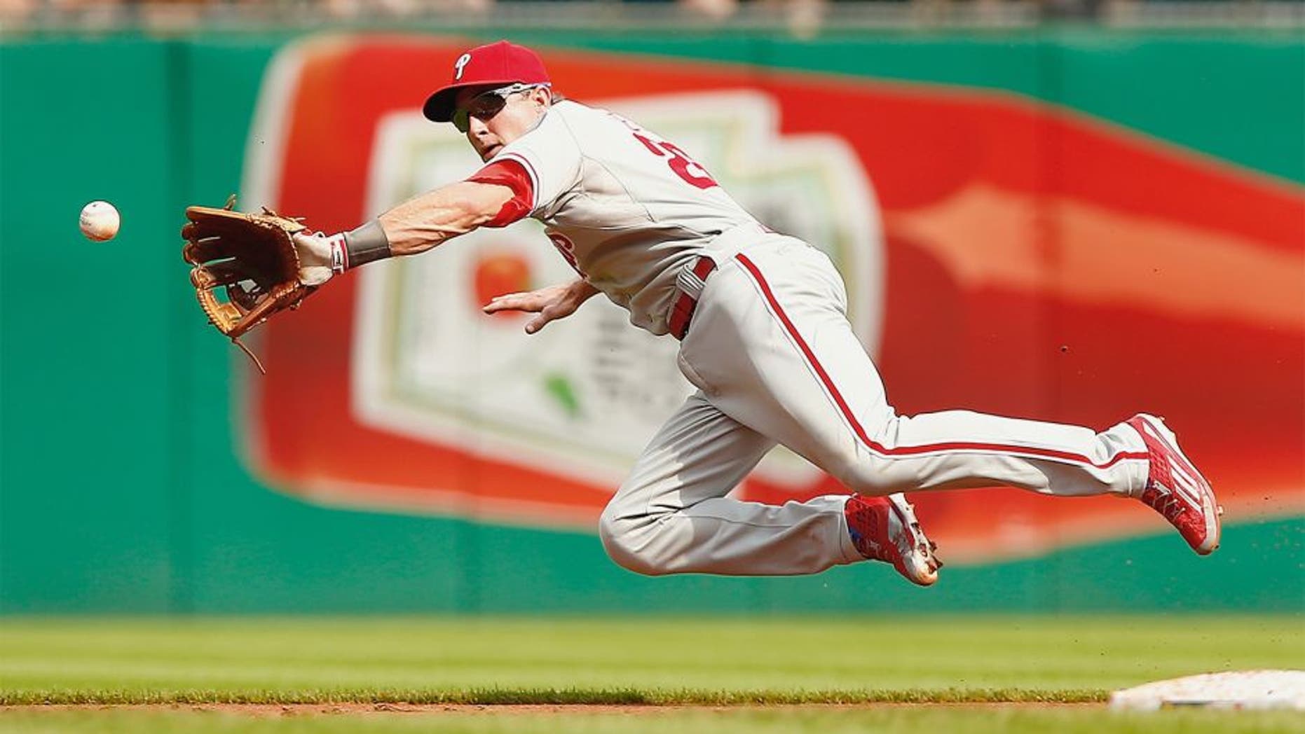 PITTSBURGH, PA - JUNE 13: Chase Utley #26 of the Philadelphia Phillies fields a ground ball while midair in the second inning against the Pittsburgh Pirates during the game at PNC Park on June 13, 2015 in Pittsburgh, Pennsylvania. (Photo by Jared Wickerham/Getty Images)