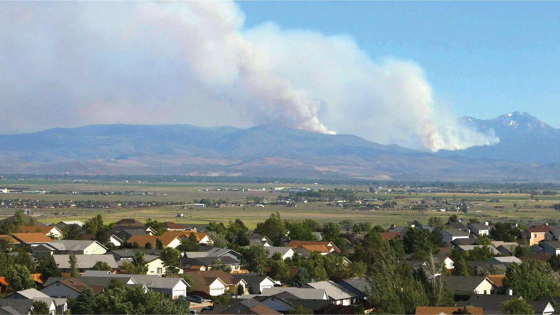 June 22, 2015: Smoke from the Washington Fire rises over the mountains in Markleeville, Calif.
