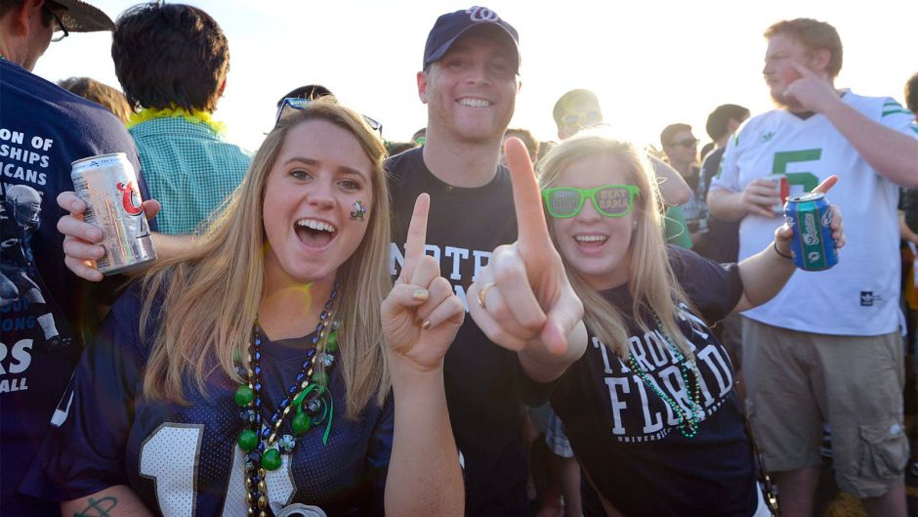 Jan 7, 2013; Miami, FL, USA; Notre Dame Fighting Irish fans Eileen Veihmeyer (left), Patrick Veihmeyer (center), and Abigail Chappell pose for a photo before the 2013 BCS Championship game against the Alabama Crimson Tide at Sun Life Stadium. Mandatory Credit: Steve Mitchell-USA TODAY Sports