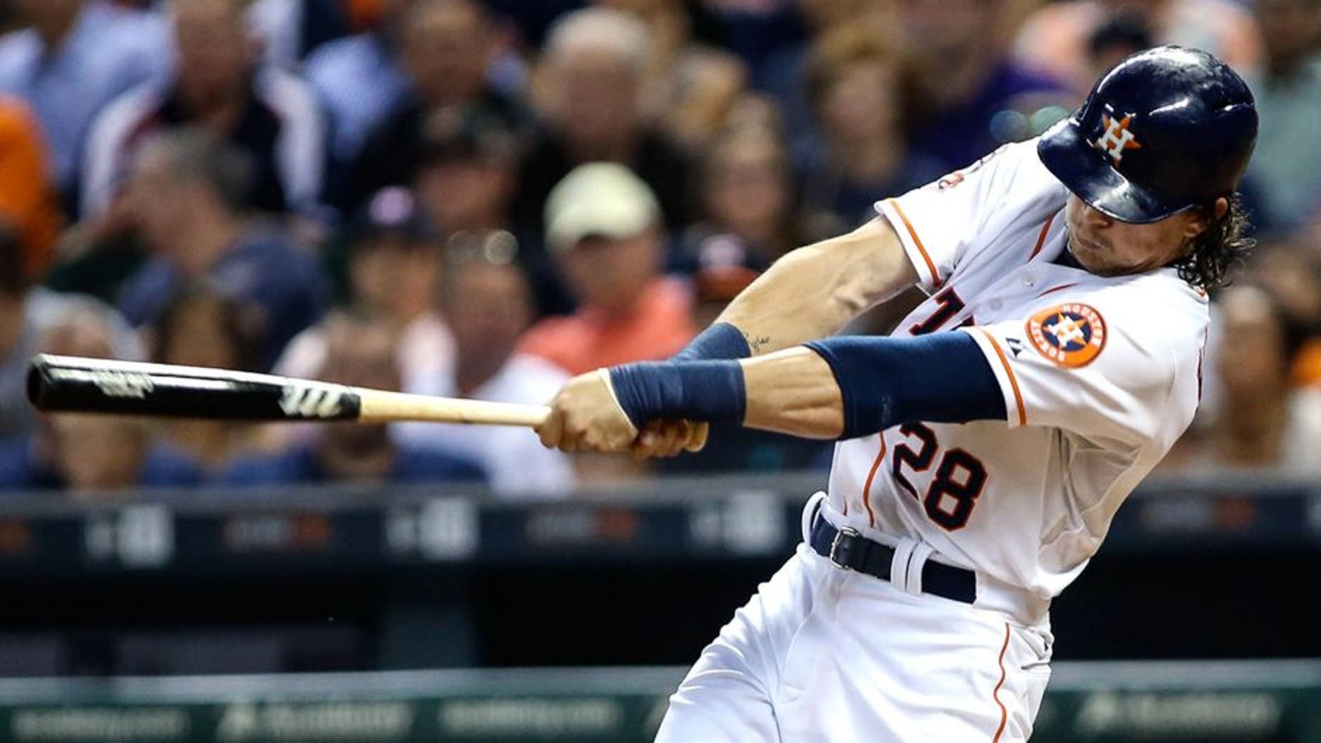 Jun 25, 2015; Houston, TX, USA; Houston Astros center fielder Colby Rasmus (28) drives in a run with a sacrifice fly during the fourth inning against the New York Yankees at Minute Maid Park. Mandatory Credit: Troy Taormina-USA TODAY Sports