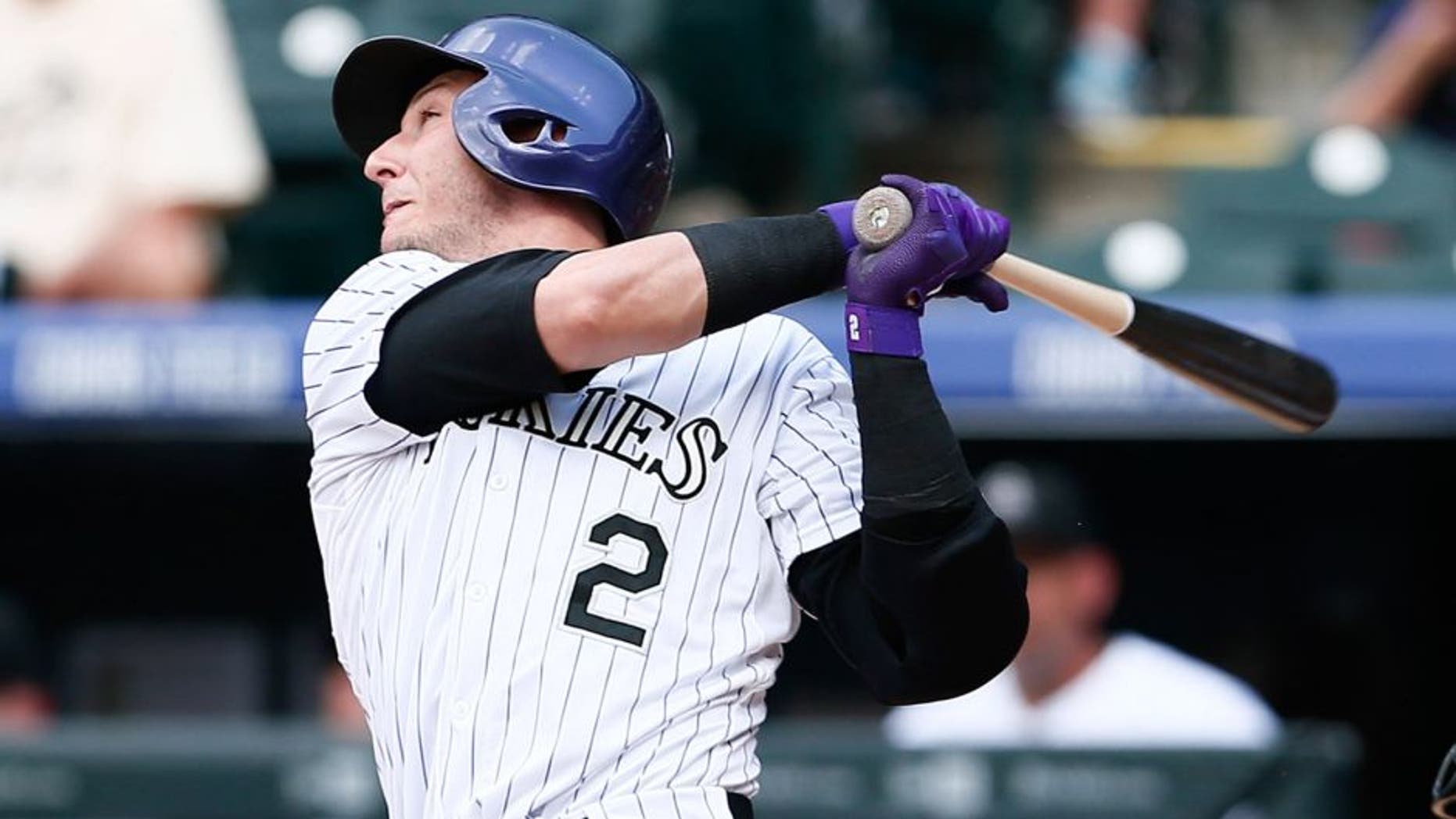 Jun 25, 2015; Denver, CO, USA; Colorado Rockies shortstop Troy Tulowitzki (2) hits a one run home run in the eighth inning against the Arizona Diamondbacks at Coors Field. The Rockies defeated the Diamondbacks 6-4. Mandatory Credit: Isaiah J. Downing-USA TODAY Sports