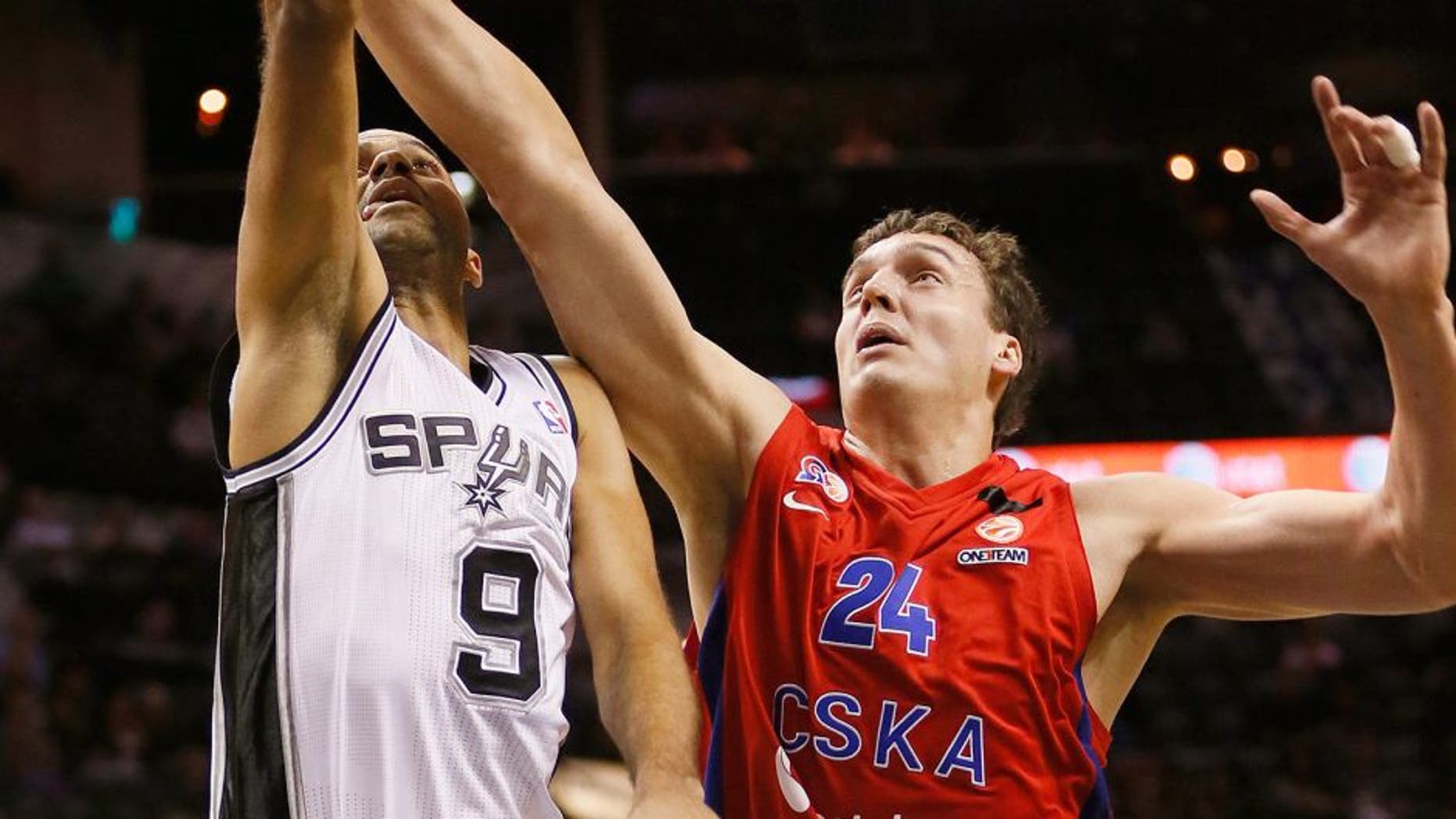 Oct 9, 2013; San Antonio, TX, USA; San Antonio Spurs guard Tony Parker (9) drives to the basket as CSKA Moscow center Sasha Kaun (24) defends during the first half at the AT&T Center. Mandatory Credit: Soobum Im-USA TODAY Sports