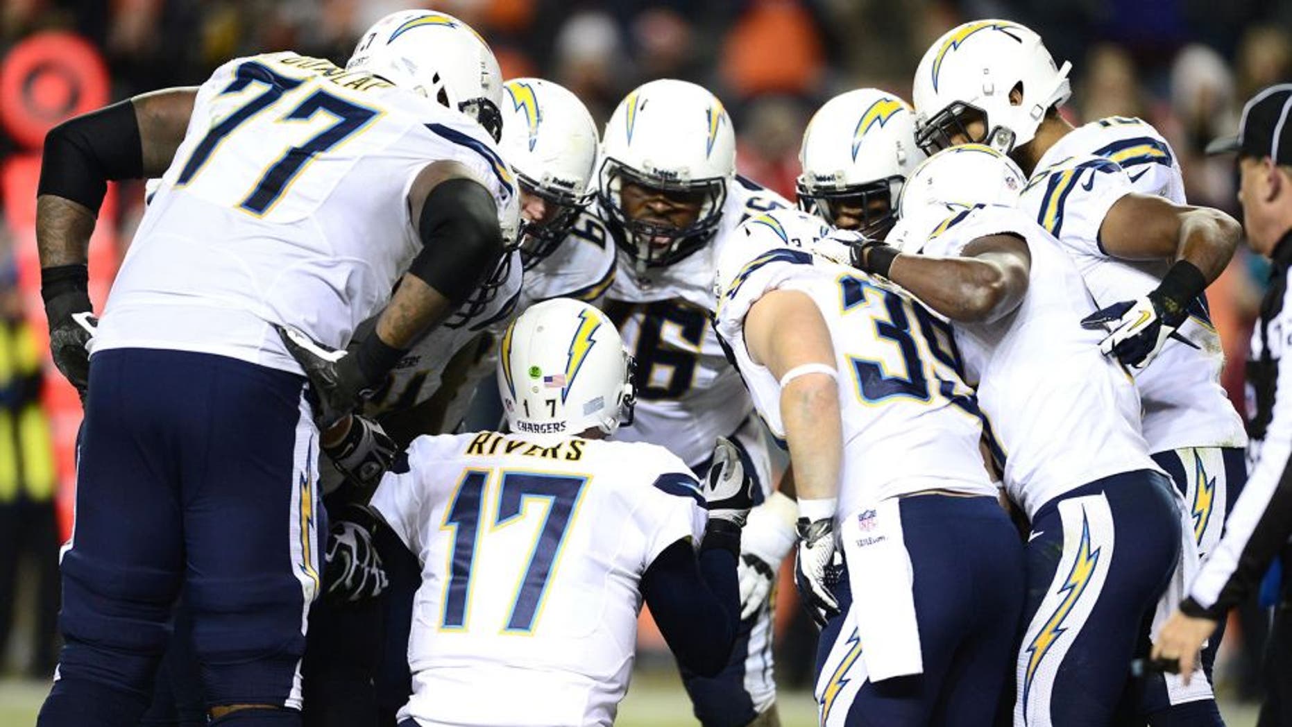 Dec 12, 2013; Denver, CO, USA; San Diego Chargers quarterback Philip Rivers (17) huddles with center Nick Hardwick (61) and tackle King Dunlap (77) and offensive tackle D.J. Fluker (76) and running back Danny Woodhead (39) and wide receiver Vincent Brown (86) and wide receiver Keenan Allen (13) and tight end Antonio Gates (85) in the fourth quarter against the Denver Broncos at Sports Authority Field at Mile High. The San Diego Chargers defeated the Denver Broncos 27-20. Mandatory Credit: Ron Chenoy-USA TODAY Sports