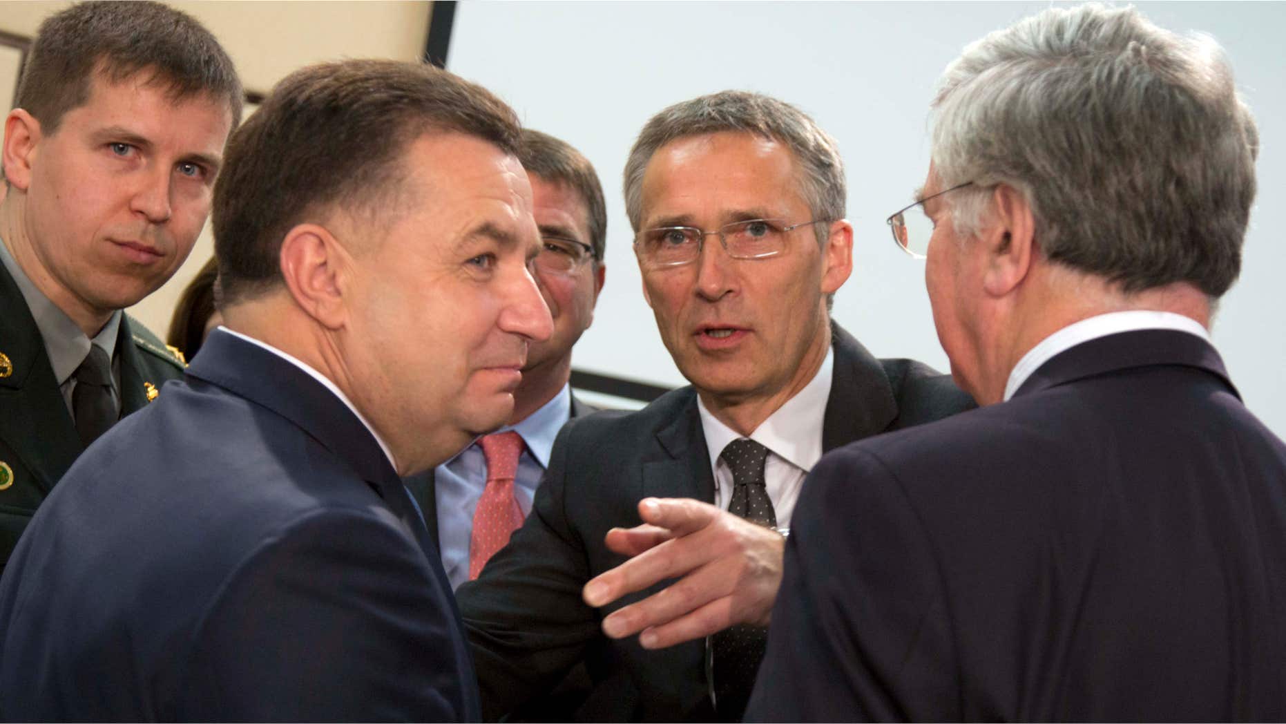 June 25, 2015: NATO Secretary General Jens Stoltenberg, second right, speaks with Ukraine's Defense Minister Stepan Poltorak, second left, during a meeting of the NATO-Ukraine Commission at NATO headquarters in Brussels.