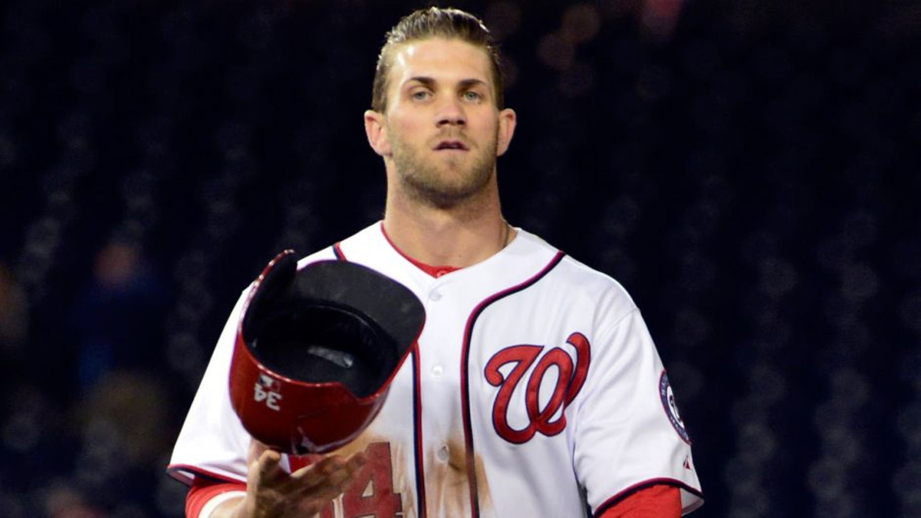 Apr 24, 2014; Washington, DC, USA; Washington Nationals left fielder Bryce Harper (34) walks off the field after being thrown out at second base in the twelfth inning to end the game against the San Diego Padres at Nationals Park. San Diego Padres defeated Washington Nationals 4-3. Mandatory Credit: Tommy Gilligan-USA TODAY Sports