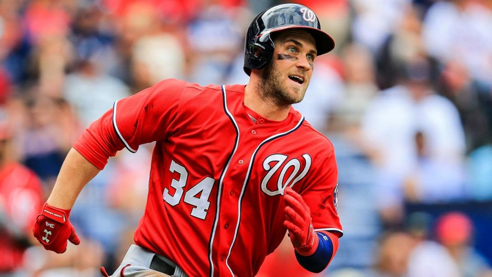 Apr 13, 2014; Atlanta, GA, USA; Washington Nationals left fielder Bryce Harper (34) runs to first on a double in the sixth inning against the Atlanta Braves at Turner Field. Mandatory Credit: Daniel Shirey-USA TODAY Sports