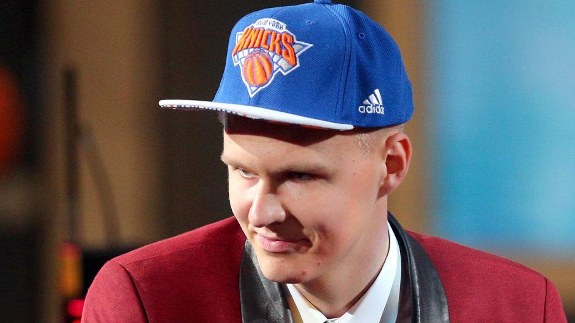 Jun 25, 2015; Brooklyn, NY, USA; Kristaps Porzingis (SPN) reacts after being selected as the number four overall pick to the Miami Heat in the first round of the 2015 NBA Draft at Barclays Center. Mandatory Credit: Brad Penner-USA TODAY Sports