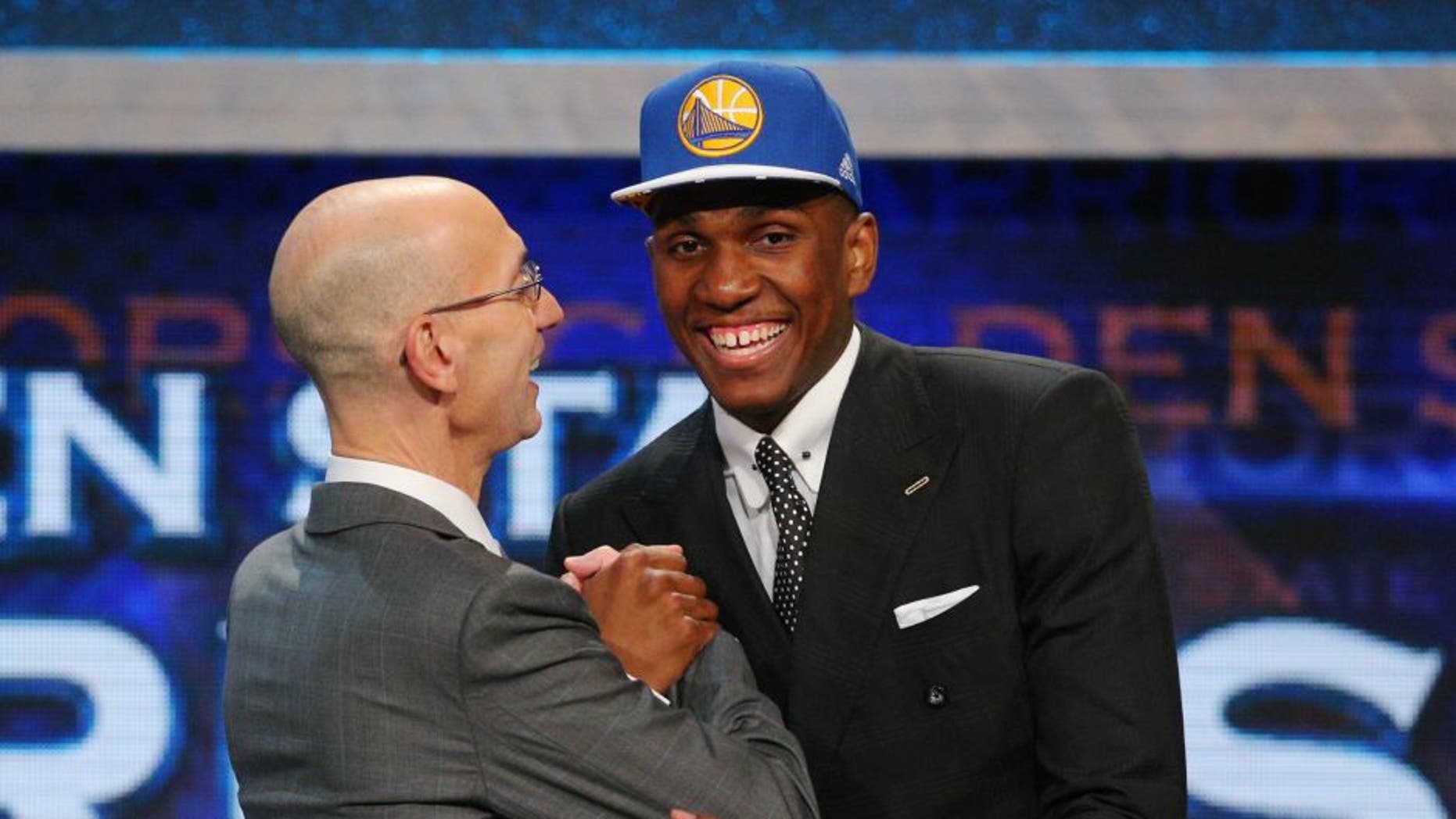 Jun 25, 2015; Brooklyn, NY, USA; Kevon Looney (UCLA) greets NBA commissioner Adam Silver after being selected as the number thirty overall pick to the Golden State Warriors in the first round of the 2015 NBA Draft at Barclays Center. Mandatory Credit: Brad Penner-USA TODAY Sports