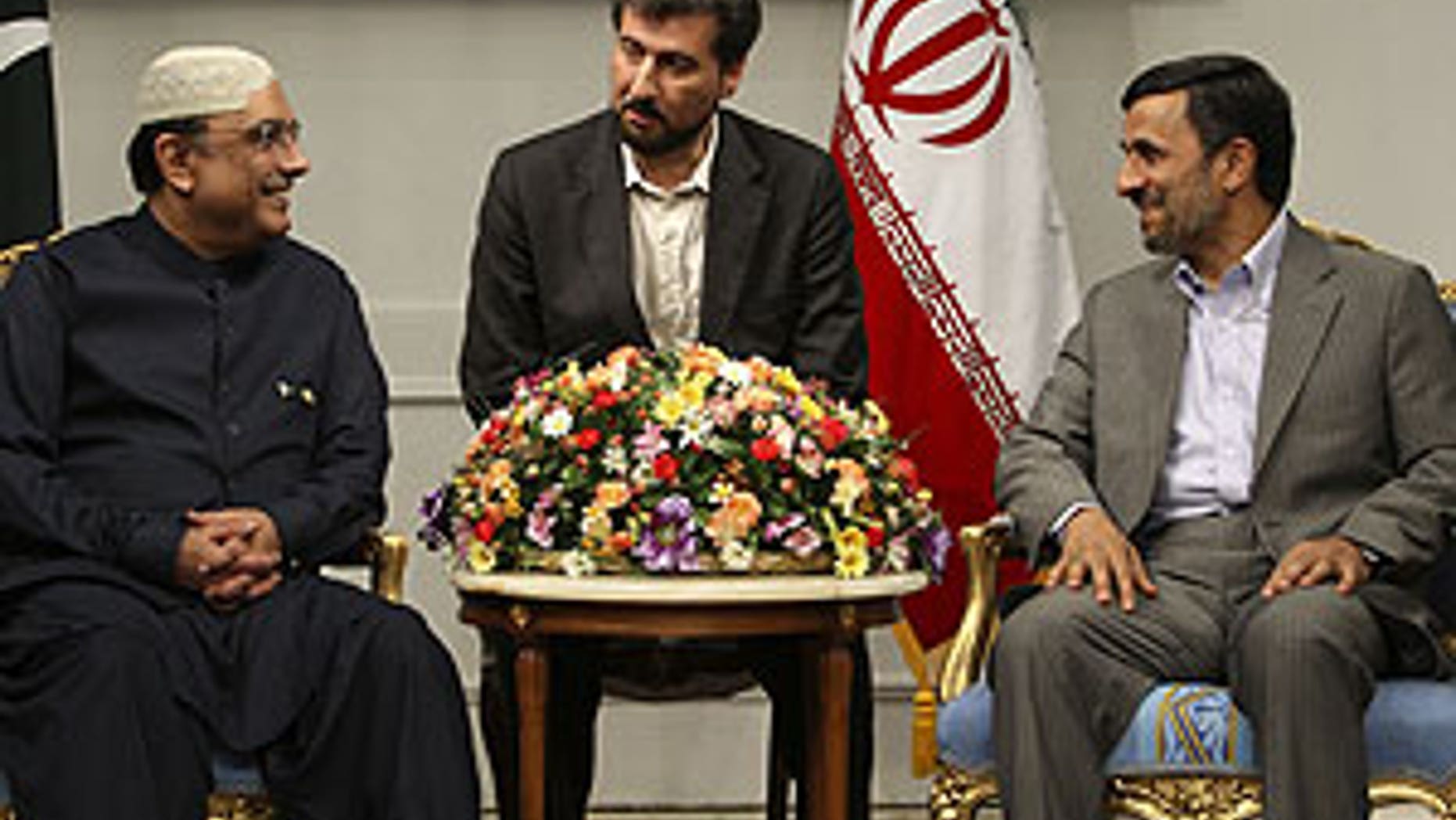 June 24: Iranian President Mahmoud Ahmadinejad, right, and his Pakistani counterpart Asif Ali Zardari meet at the Iranian presidency office in Tehran, Iran. At center is an unidentified interpreter.