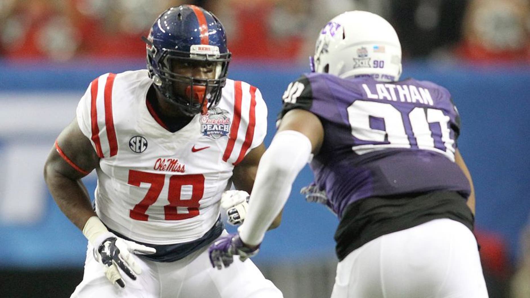 Dec 31, 2014; Atlanta , GA, USA; Mississippi Rebels offensive lineman Laremy Tunsil (78) prepares to block TCU Horned Frogs defensive tackle Terrell Lathan (90) during the first quarter in the 2014 Peach Bowl at the Georgia Dome. Mandatory Credit: Brett Davis-USA TODAY Sports