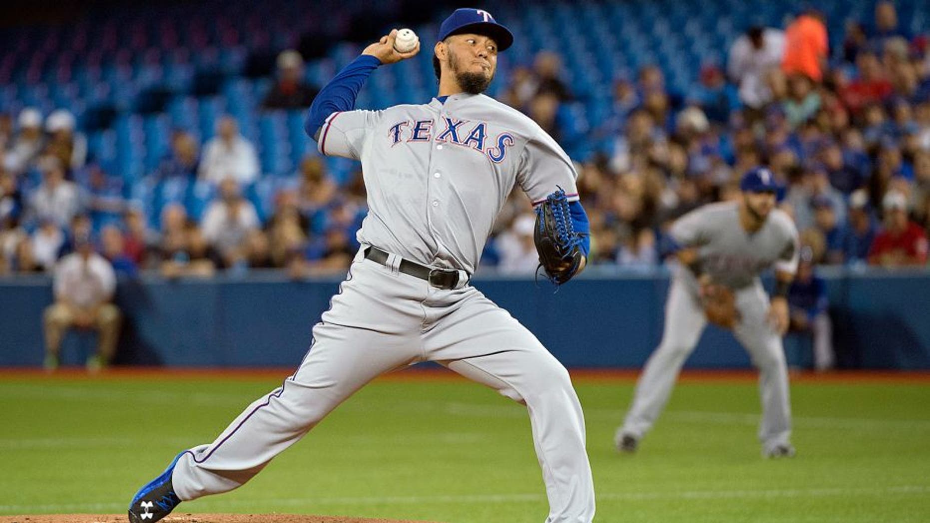 Jun 27, 2015; Toronto, Ontario, CAN; Texas Rangers starting pitcher Yovani Gallardo (49) throws a pitch during the first inning in a game against the Toronto Blue Jays at Rogers Centre. Mandatory Credit: Nick Turchiaro-USA TODAY Sports