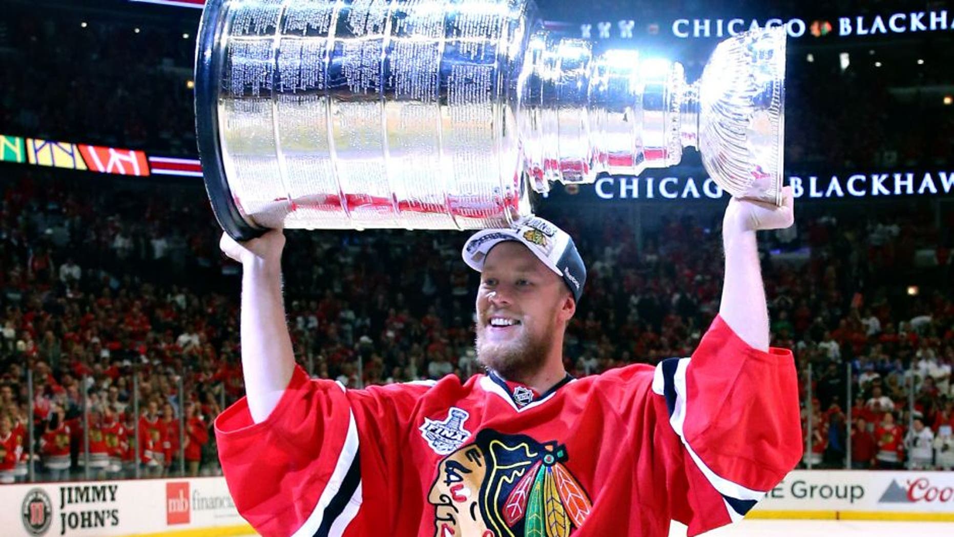 CHICAGO, IL - JUNE 15: Antti Raanta #31 of the Chicago Blackhawks celebrates with the Stanley Cup after defeating the Tampa Bay Lightning by a score of 2-0 in Game Six to win the 2015 NHL Stanley Cup Final at the United Center on June 15, 2015 in Chicago, Illinois. (Photo by Bruce Bennett/Getty Images)