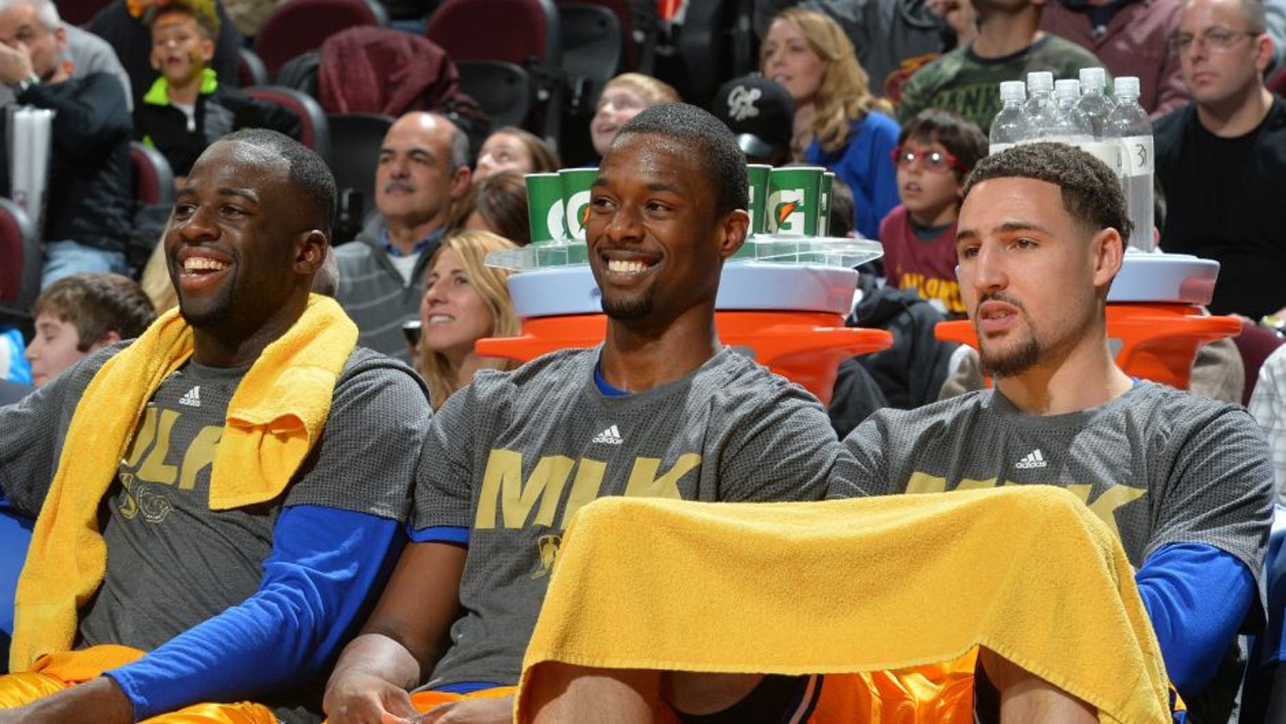 CLEVELAND, OH - JANUARY 18: Harrison Barnes #40, Draymond Green #23 , Stephen Curry #30 and Klay Thompson #11 of the Golden State Warriors smiles from the bench against the Cleveland Cavaliers on January 18, 2016 at Quicken Loans Arena in Cleveland, Ohio. NOTE TO USER: User expressly acknowledges and agrees that, by downloading and/or using this Photograph, user is consenting to the terms and conditions of the Getty Images License Agreement. Mandatory Copyright Notice: Copyright 2016 NBAE (Photo by Jesse D. Garrabrant/NBAE via Getty Images)