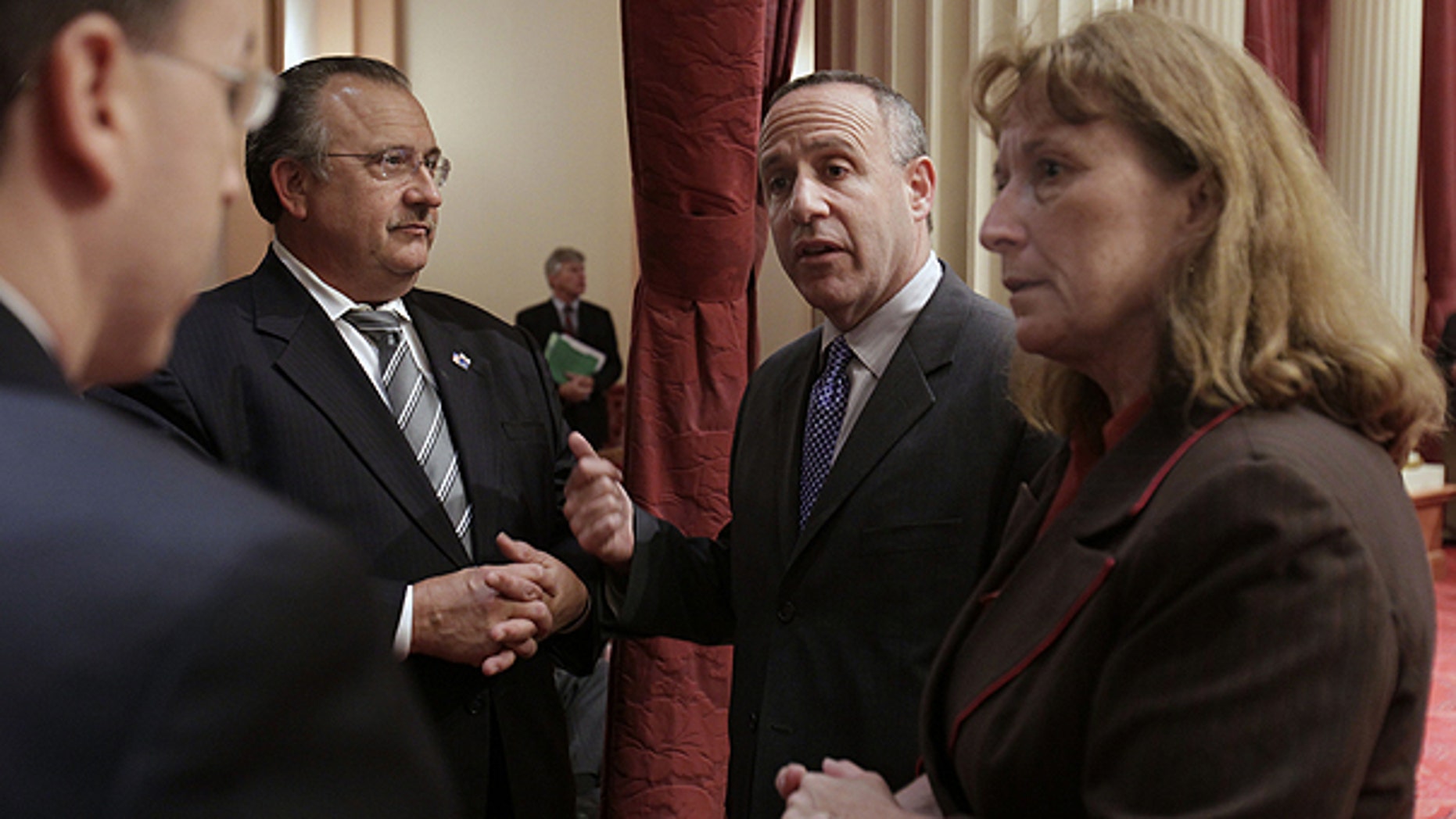 June 28: State Senate President Pro Tem Darrell Steinberg, D-Sacramento, second right, confers with Senate Minority Leader Bob Dutton, R-Rancho Cucamonga, second left, Repulican Senate Caucus Chief of Staff Kevin Bassett, left, and Sen. Ellen Corbett, D-San Leandro, at the Capitol in Sacramento, Calif.