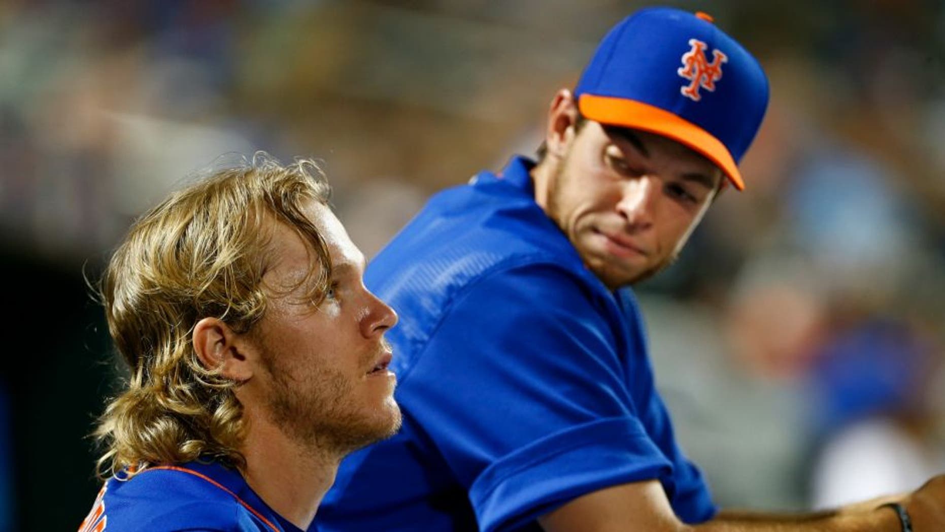 NEW YORK, NY - JULY 10: Pitchers Noah Syndergaard #34, talks with Steven Matz of the New York Mets in the dugout during a game against the Arizona Diamondbacks on July 10, 2015 at Citi Field in the Flushing neighborhood of the Queens borough of New York City. (Photo by Rich Schultz/Getty Images)