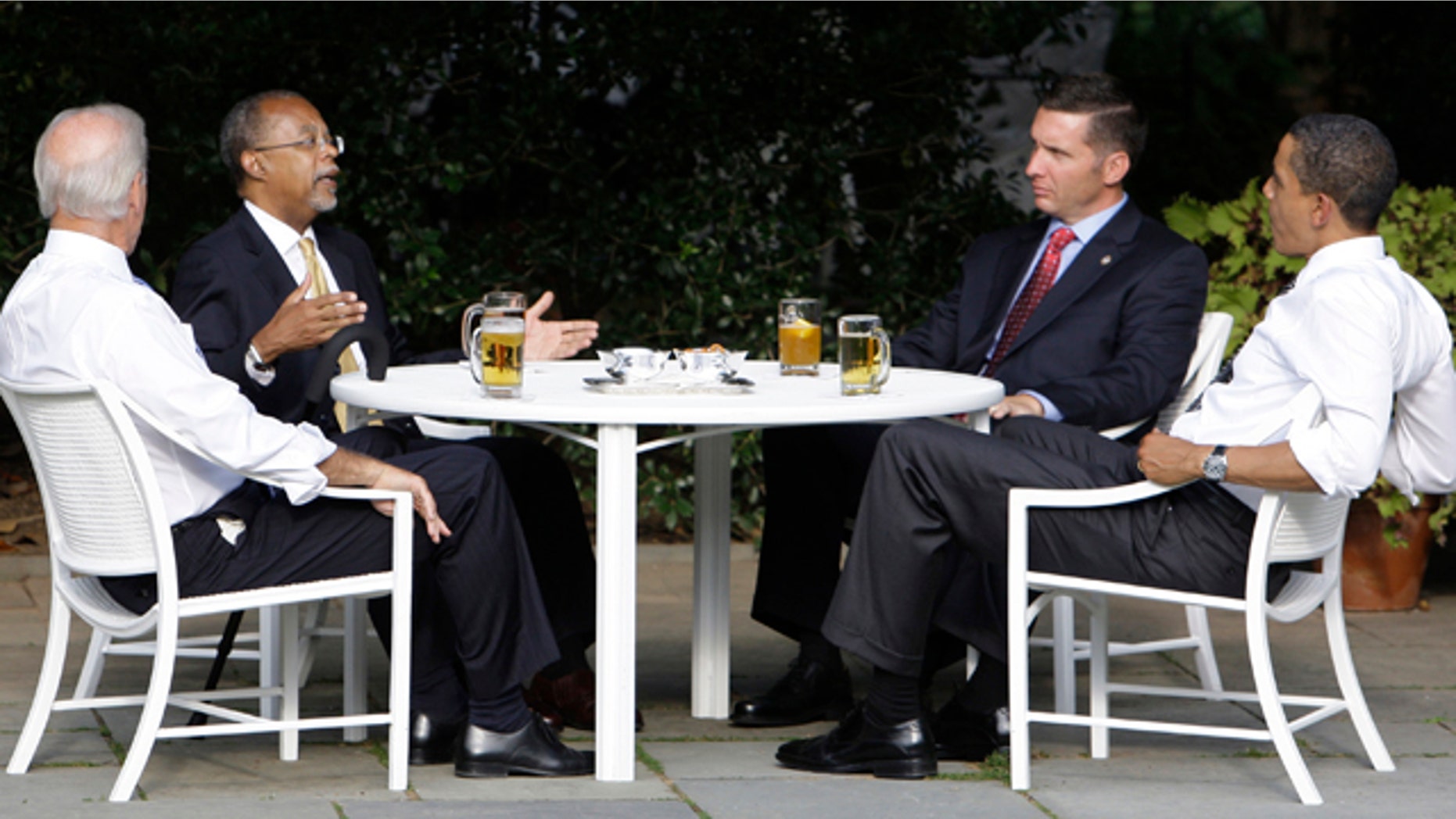 In this July 30, 2009 file photo, President Obama, right, and Vice President Biden, left, have a beer with Harvard scholar Henry Louis Gates Jr., second from left, and Cambridge, Mass., police Sgt. James Crowley in the Rose Garden of the White House in Washington.