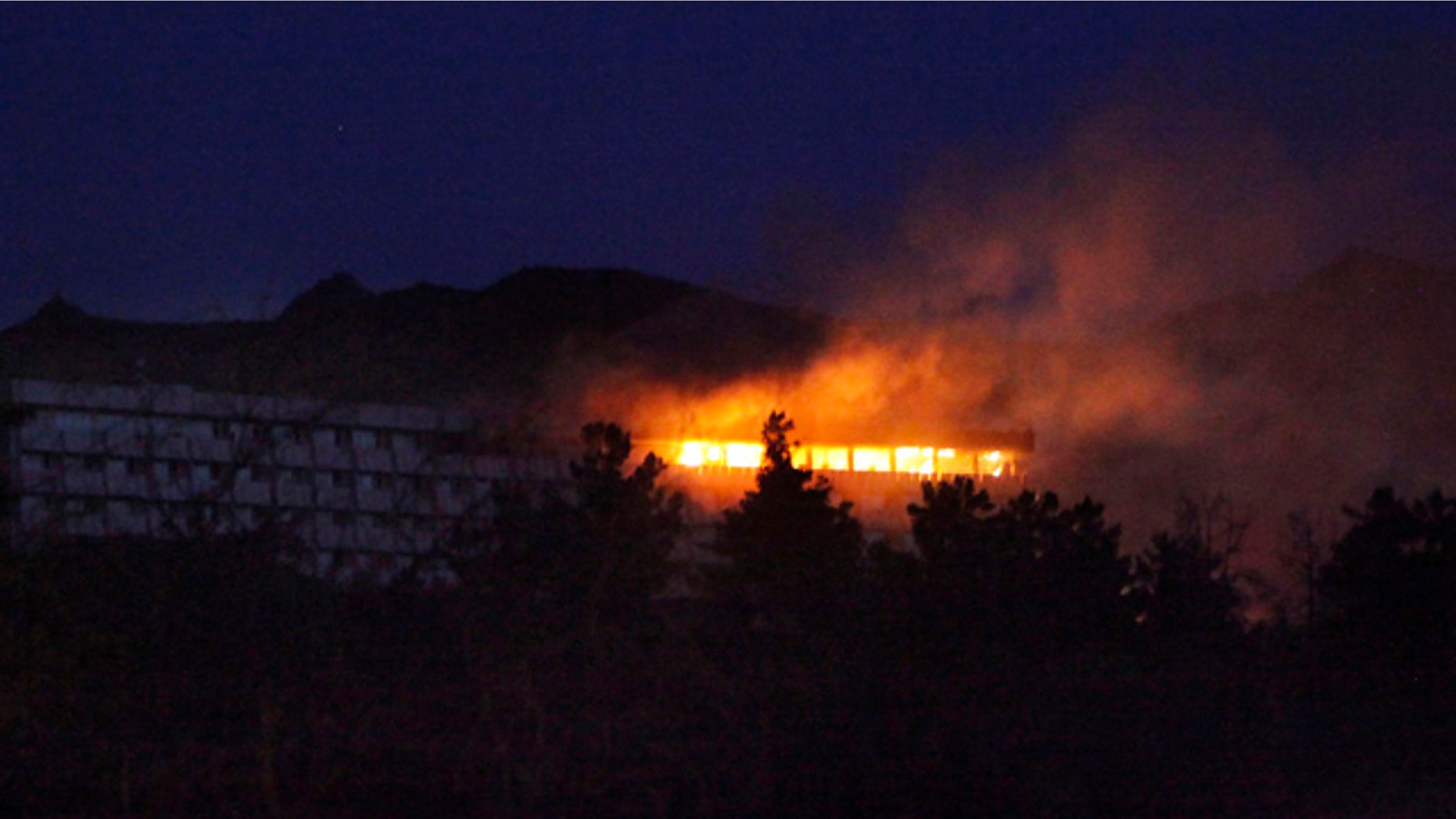 June 29: Western-style Inter-Continental hotel is on fire during an attack in Kabul, Afghanistan.
