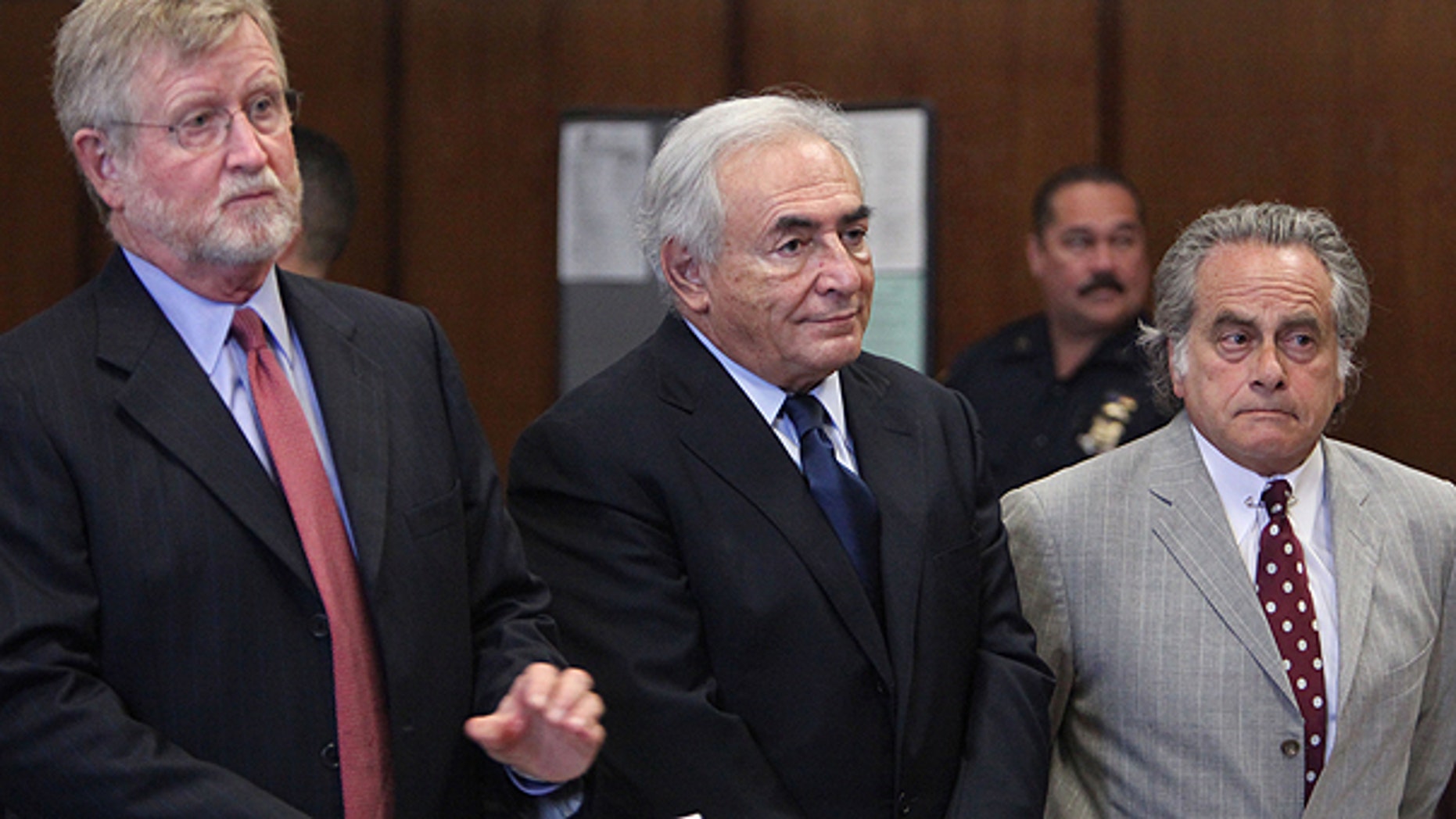 June 6: Former IMF leader Dominique Strauss-Kahn, center, appears at his arraignment on charges of sexually assaulting a Manhattan hotel maid, at Manhattan Criminal Court in New York.
