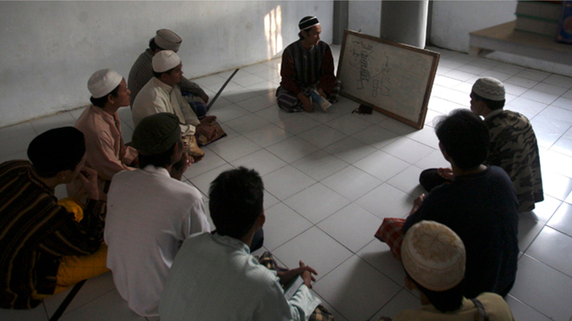 June 6: Prisoners attend a religious class led by a jailed militant Arif Syaifudin, also known as "Firdaus," in Block F of the Porong prison in East Java, Indonesia.