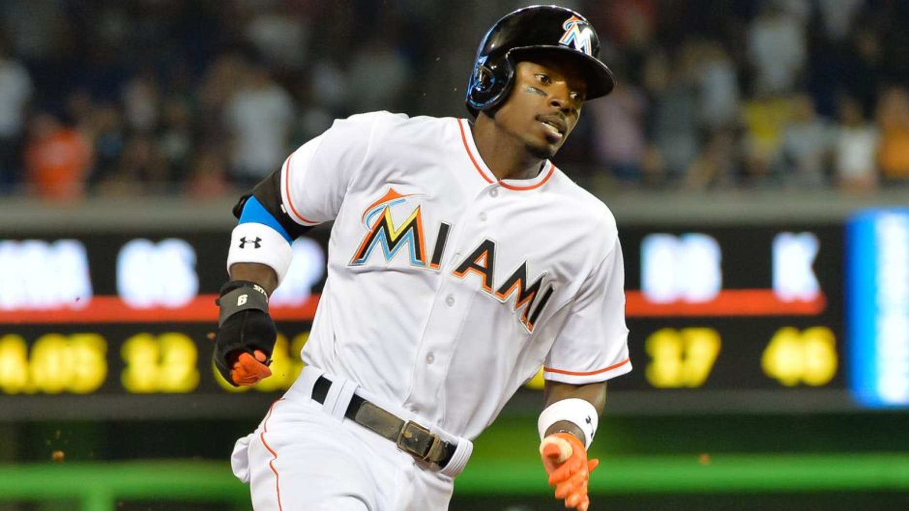 Jun 16, 2015; Miami, FL, USA; Miami Marlins second baseman Dee Gordon (9) runs the bases and scores a run during the first inning against the New York Yankees at Marlins Park. Mandatory Credit: Steve Mitchell-USA TODAY Sports