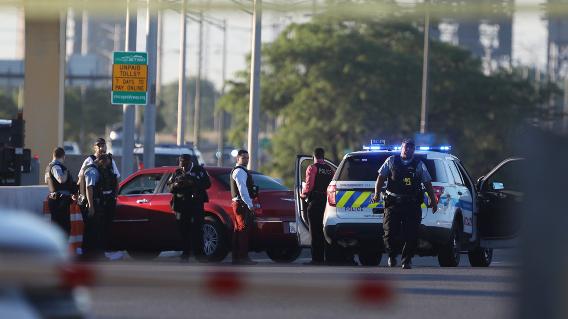 Chicago police work at the scene of a shooting that killed multiple people on the Chicago Skyway early Wednesday, June 21, 2017, in Chicago.
