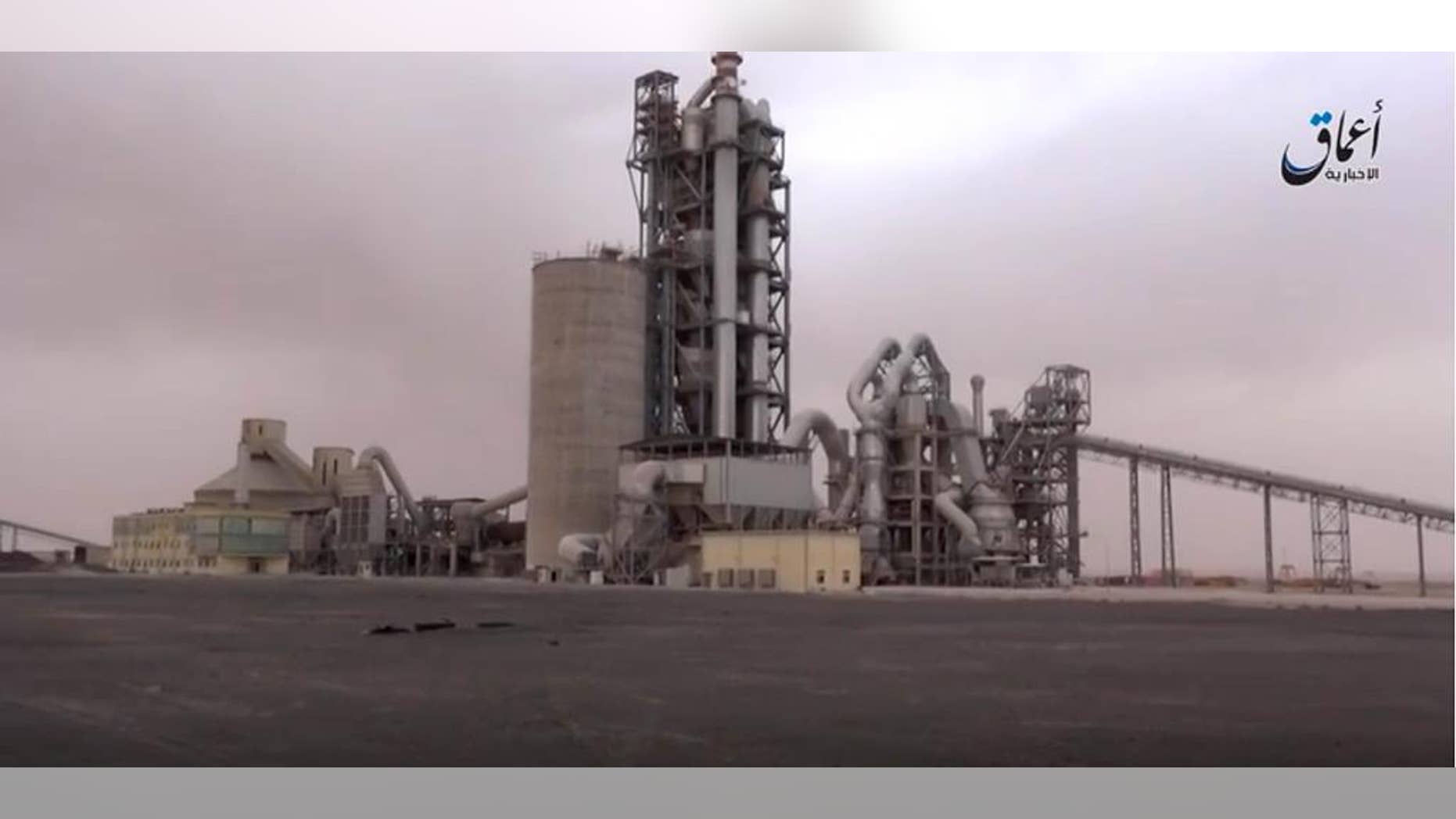 This image made from video published online by Amaq News Agency of the Islamic State group shows a cement factory where in a brazen assault near the Syrian capital, Islamic State militants snatched up to 300 cement workers and contractors from their workplace northeast of Damascus Thursday, April 7, 2016. (militant video via AP)