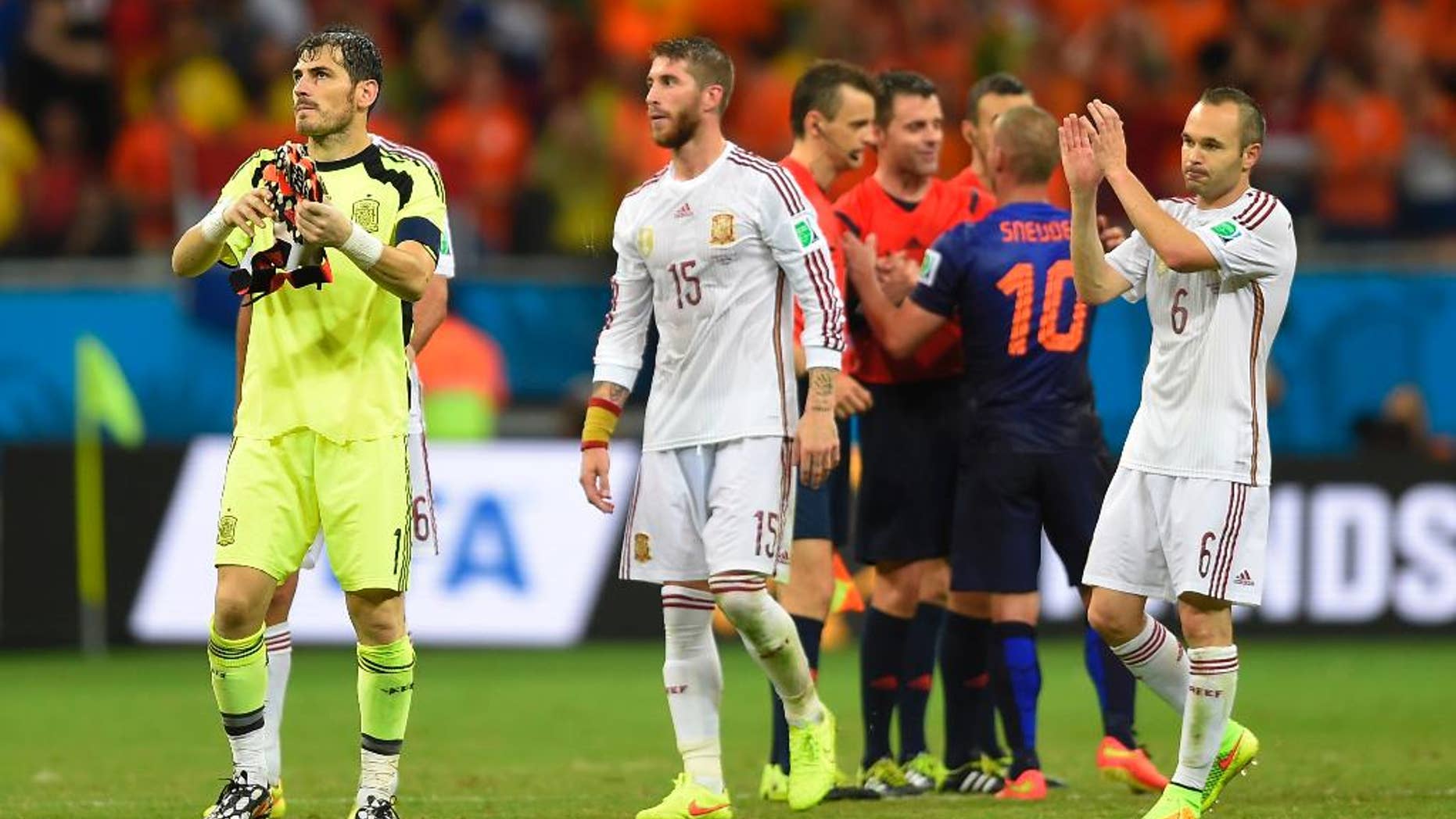 Spain's goalkeeper Iker Casillas, left, Spain's Sergio Ramos, centre and Spain's Andres Iniesta react after the group B World Cup soccer match between Spain and the Netherlands at the Arena Ponte Nova in Salvador, Brazil, Friday, June 13, 2014. The Netherlands won the match 5-1. (AP Photo/Manu Fernandez)