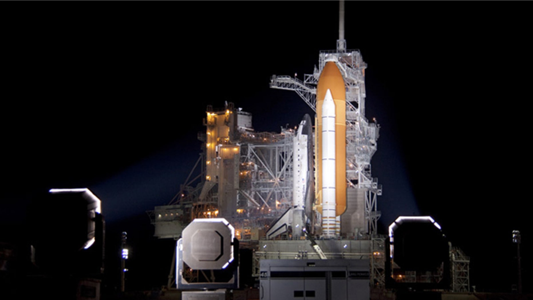 At NASA's Kennedy Space Center in Florida, xenon lights illuminate space shuttle Discovery on Launch Pad 39A following the retraction of the rotating service structure on Nov. 3.