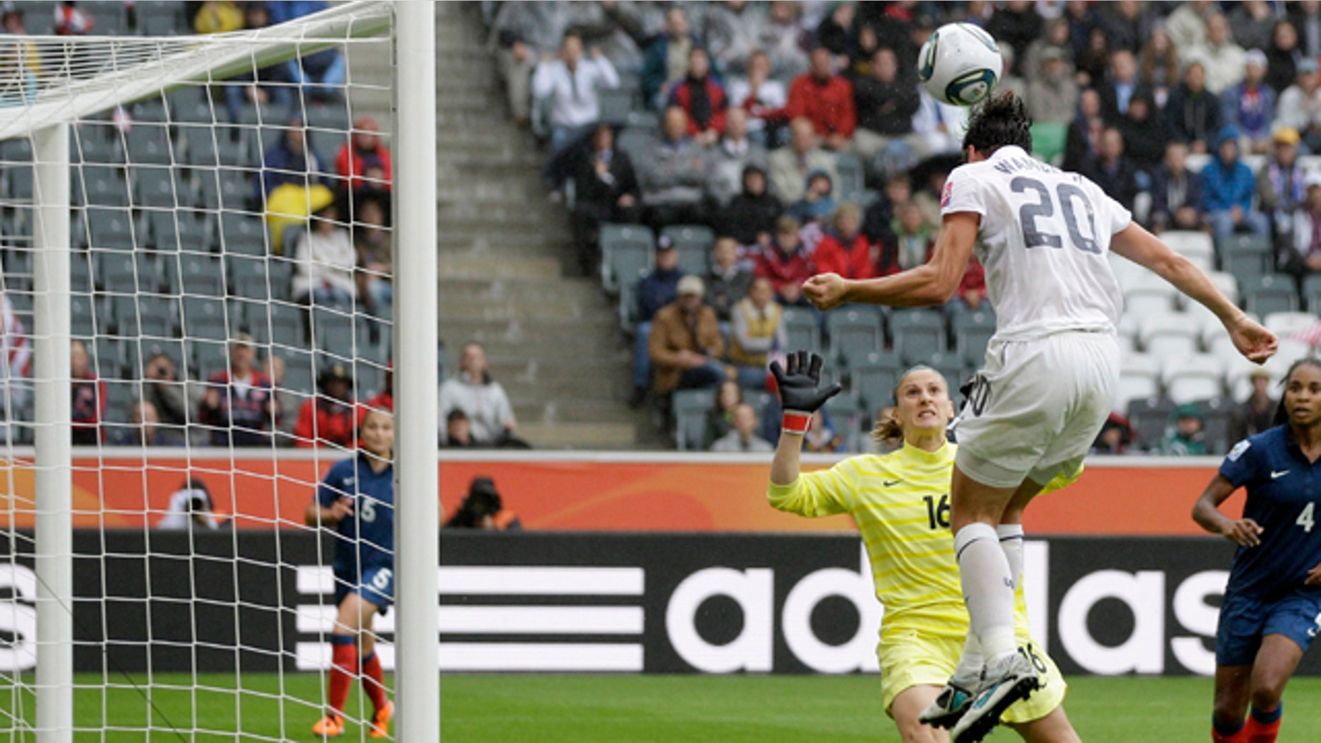 United States' Abby Wambach, right, heads the ball past France goalkeeper Berangere Sapowicz during the semifinal match between France and the United States at the Womens Soccer World Cup in Moenchengladbach, Germany, Wednesday, July 13, 2011. (AP Photo/Marcio Jose Sanchez)
