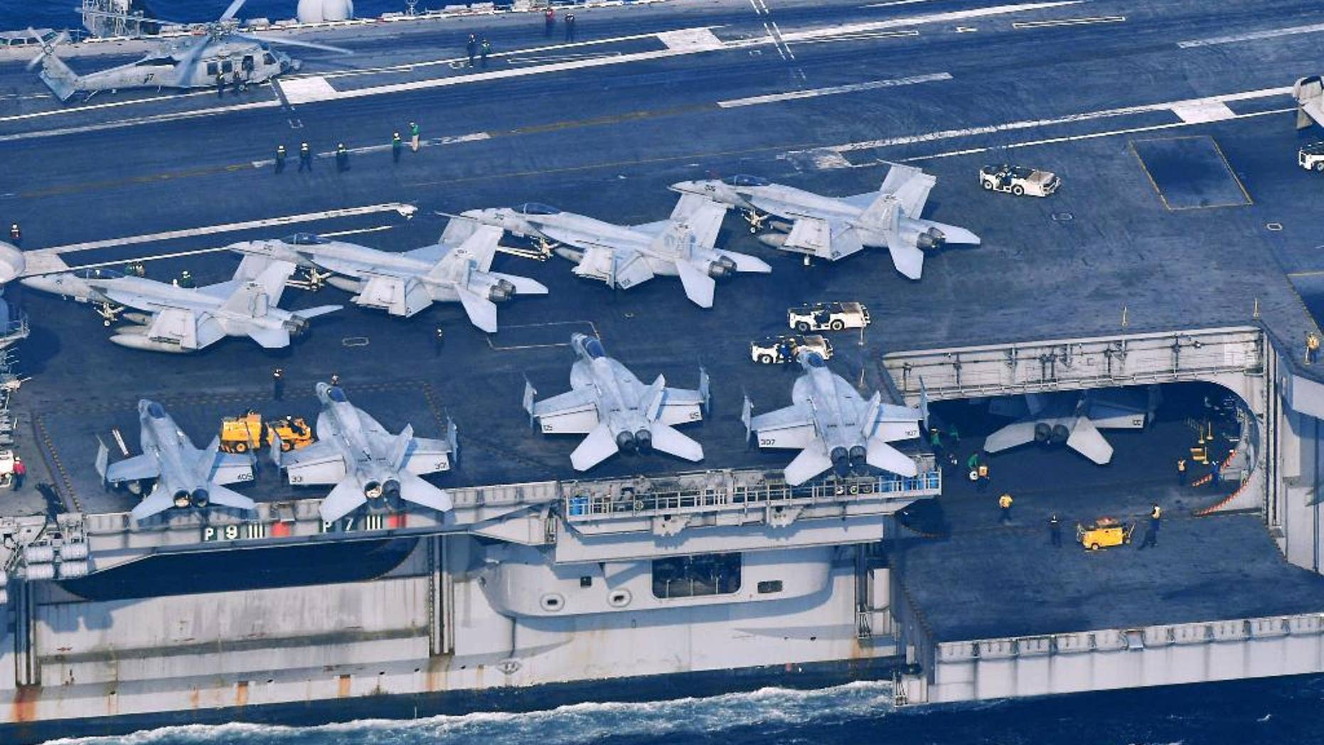 The USS Carl Vinson sails offshore Nagasaki prefecture, southern Japan Saturday, April 29, 2017. The USS Carl Vinson is heading north toward the Korean peninsula in a show of force after satellite images suggested North Korea may be preparing to conduct a nuclear test. A North Korean mid-range ballistic missile apparently failed shortly after launch Saturday, South Korea and the United States said, the third test-fire flop just this month but a clear message of defiance as a U.S. supercarrier conducts drills in nearby waters. (Kyodo News via AP)
