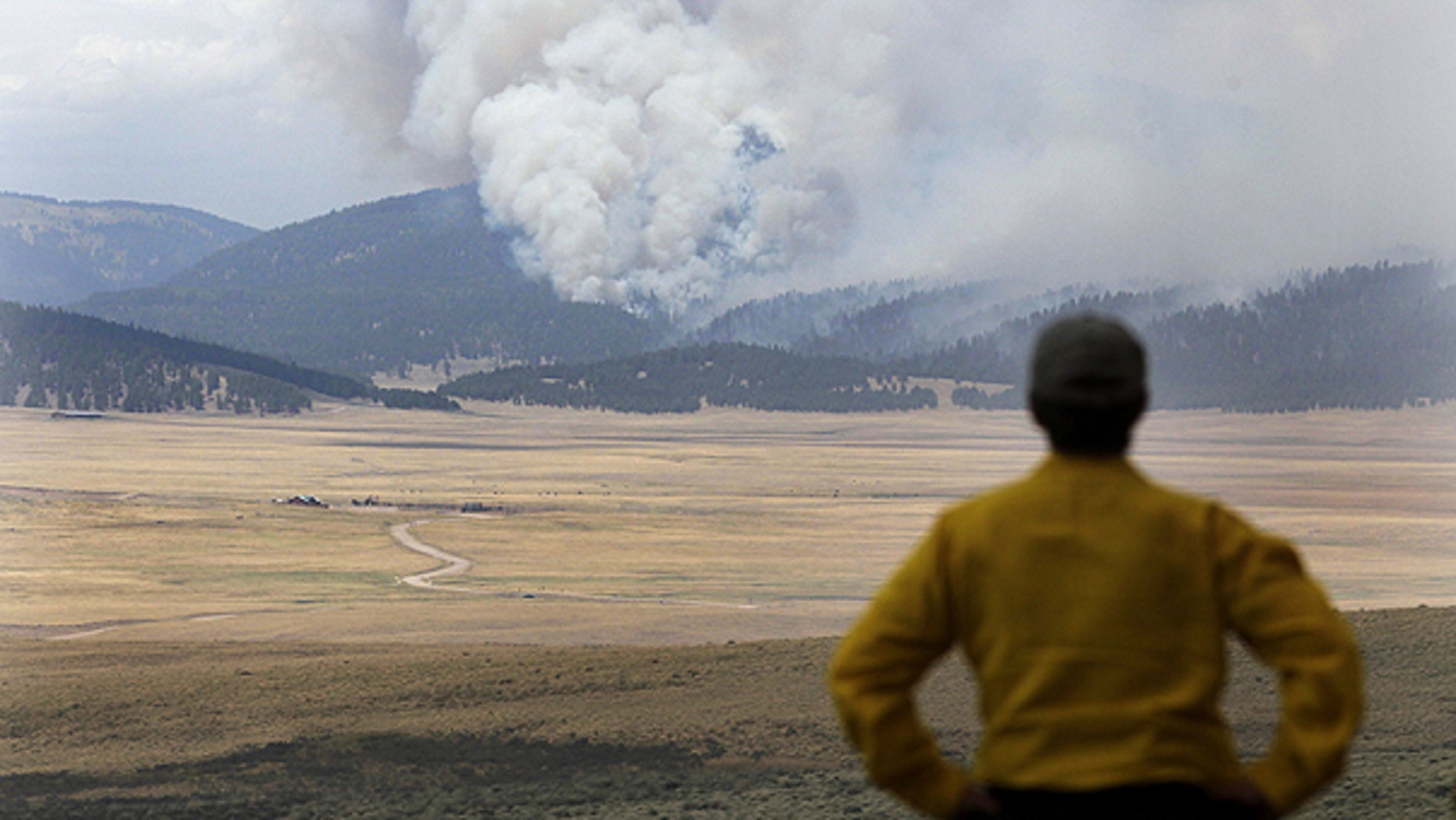 June 30: A television producer watches smoke from the Las Conchas fire near Los Alamos, N.M.
