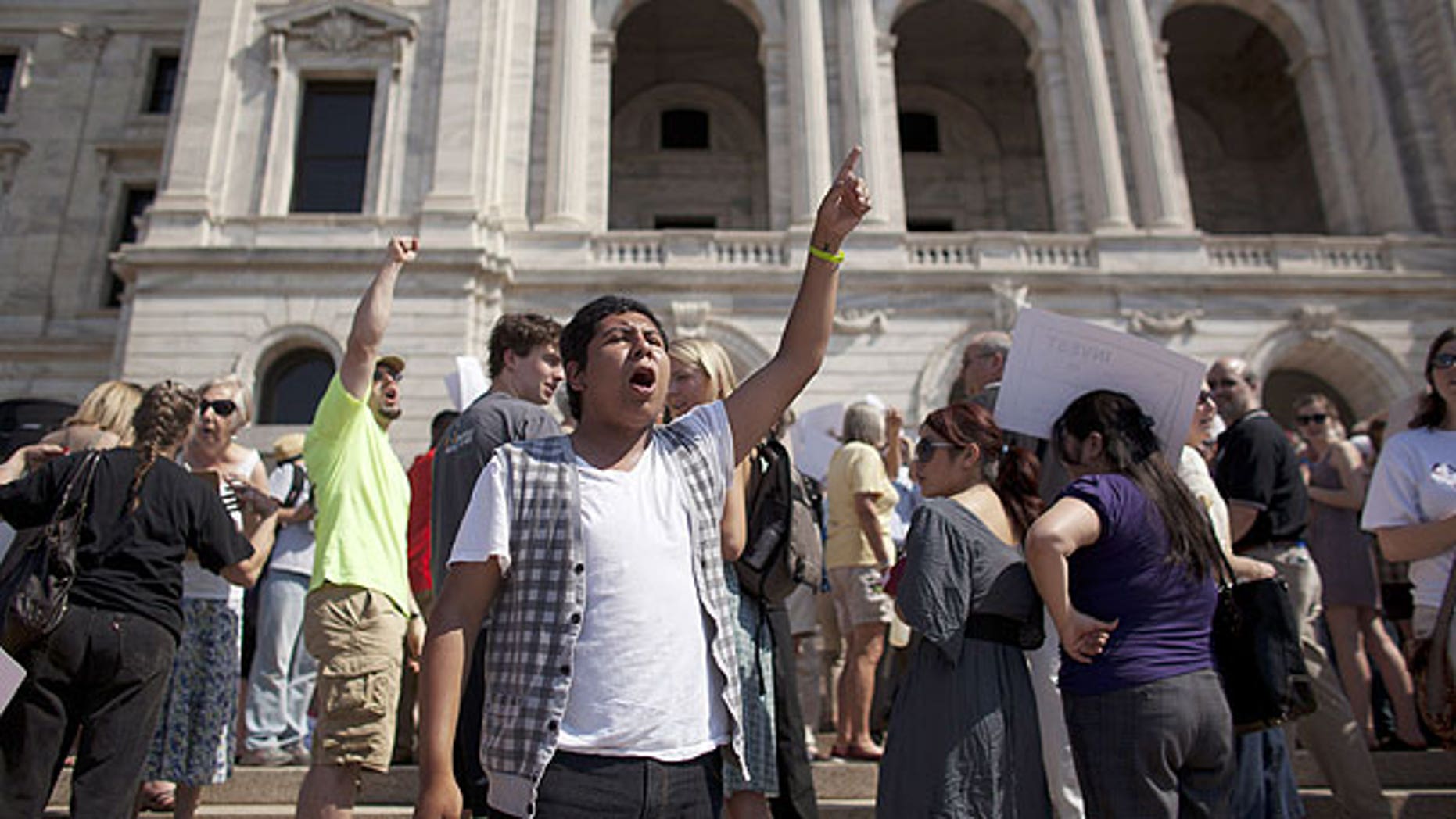 June 30: Richard Aviles of Northfield, Minn., leads the chanting of demonstrators opposed to a state shutdown on the steps of the state Capitol in St. Paul, Minn., (AP Photo/Star Tribune, Jeff Wheeler) .