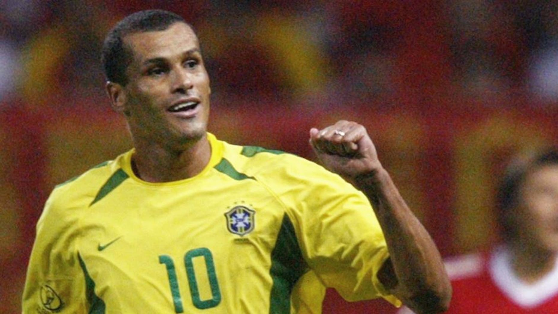 SEOGWIPO, REPUBLIC OF KOREA: Brazil's Rivaldo (L) celebrates after scoring in the 31st minute as China's Li Weifeng (R) looks on, 08 June 2002 at the Jeju World Cup Stadium in Seogwipo, during first round Group C action between Brazil and China in the 2002 FIFA World Cup Korea/Japan. AFP PHOTO/ANTONIO SCORZA (Photo credit should read ANTONIO SCORZA/AFP/Getty Images)
