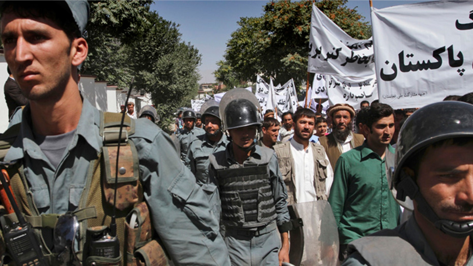 July 2: Afghan policemen escort protestors during an anti-Pakistan demonstration in Kabul, Afghanistan.