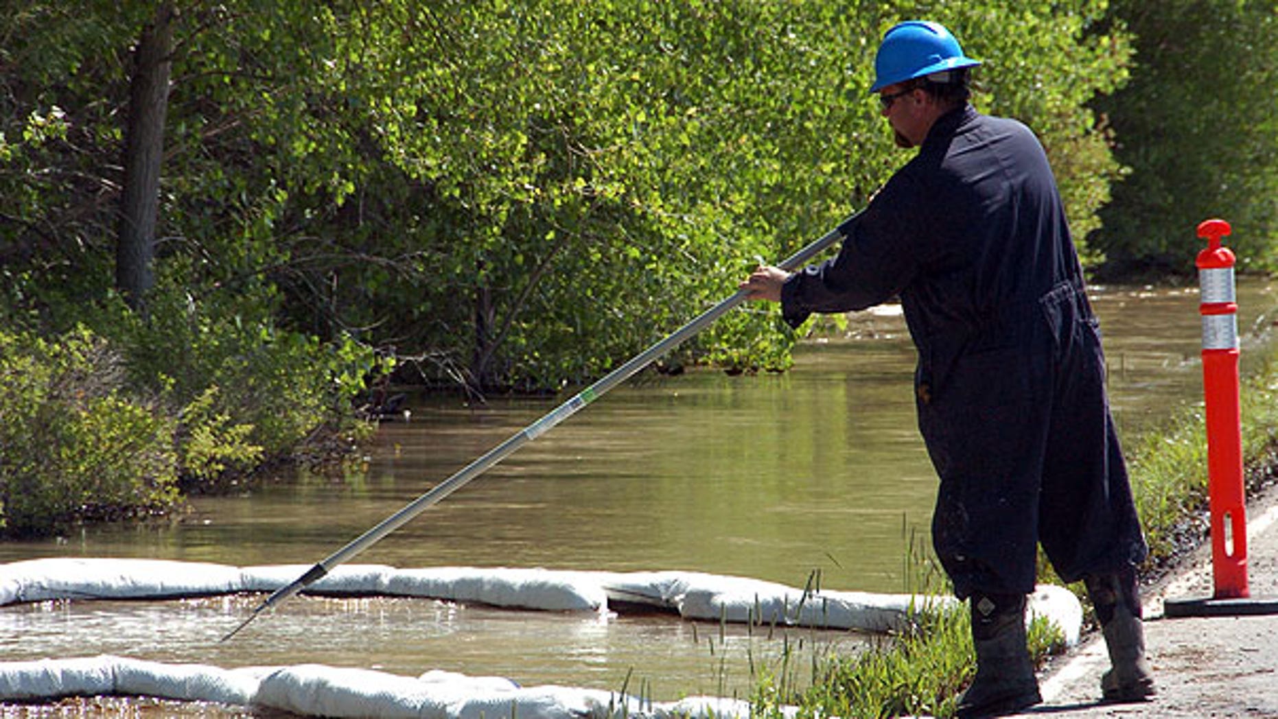 July 2: A contractor for ExxonMobil tends to an oil containment boom along the Yellowstone River near Laurel, Mont., after a pipeline that runs under the river ruptured. The pipeline break was contained early Saturday morning but the spill stretched over dozens of miles.