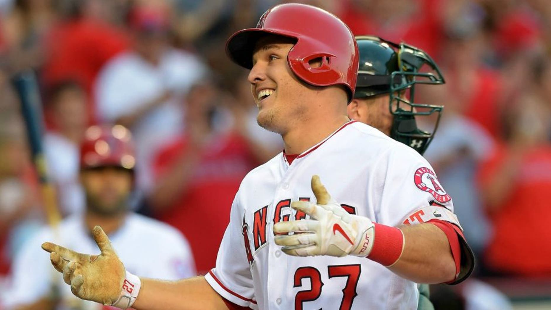 Jun 25, 2016; Anaheim, CA, USA; Los Angeles Angels center fielder Mike Trout (27) crosses the plate after a solo home run off Oakland Athletics relief pitcher Dillon Overton (47) in the first inning of the game at Angel Stadium of Anaheim. Mandatory Credit: Jayne Kamin-Oncea-USA TODAY Sports