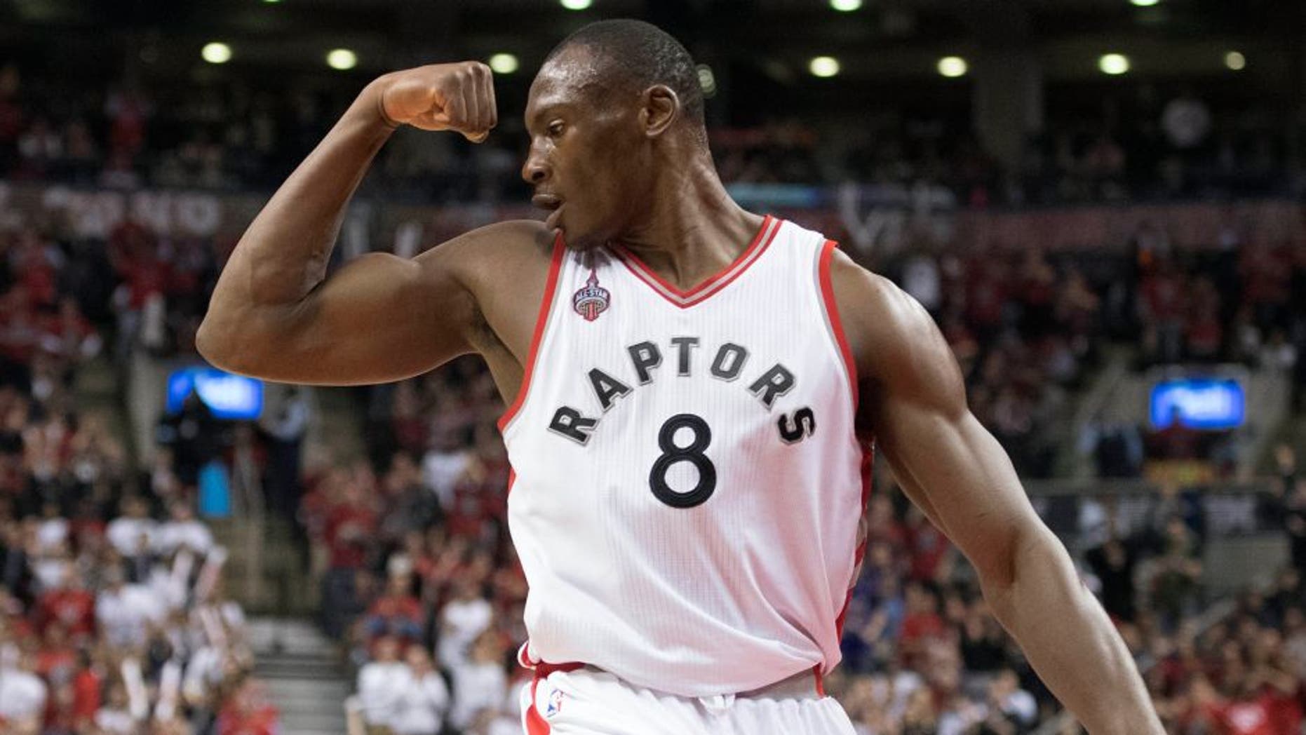 Apr 26, 2016; Toronto, Ontario, CAN; Toronto Raptors center Bismack Biyombo (8) reacts after scoring a basket during the fourth quarter in game five of the first round of the 2016 NBA Playoffs against the Indiana Pacers at Air Canada Centre. The Toronto Raptors won 102-99. Mandatory Credit: Nick Turchiaro-USA TODAY Sports